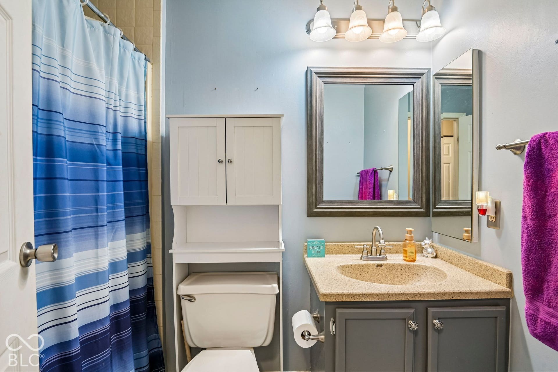 Vanity with a neutral-toned countertop and an integrated sink