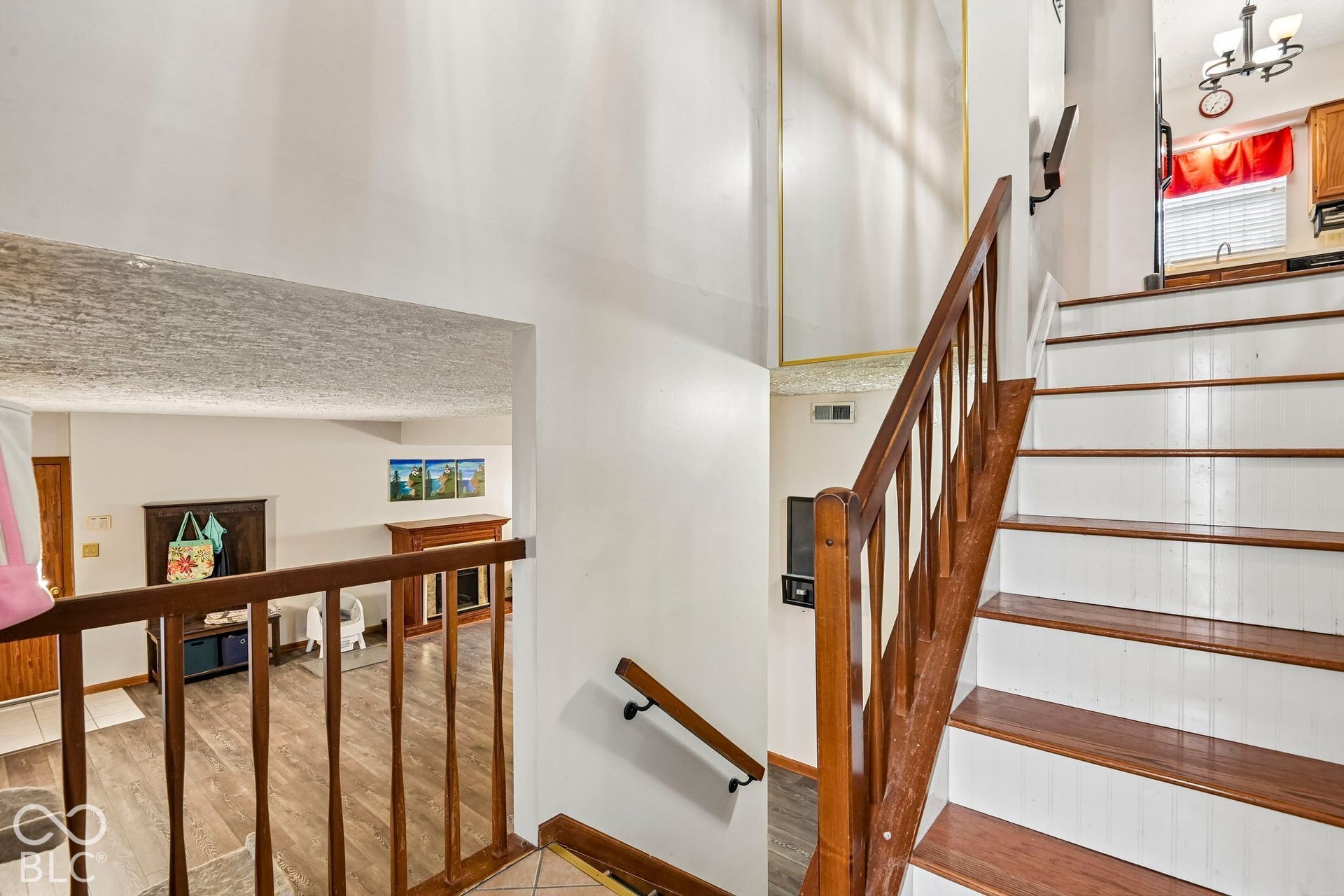 Wood-finish staircase with white risers and a matching wood-finish railing