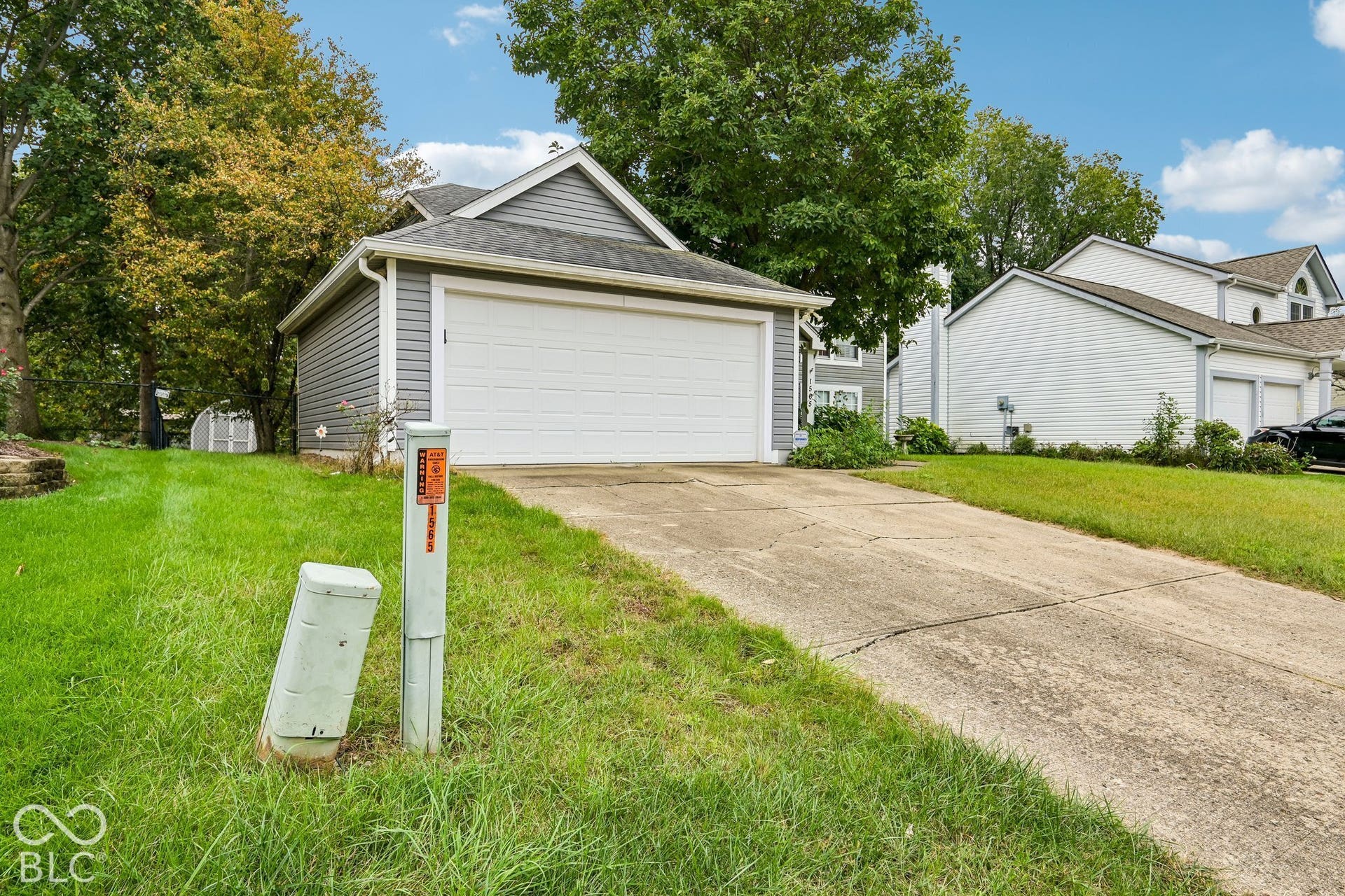 Attached two-car garage with a concrete driveway