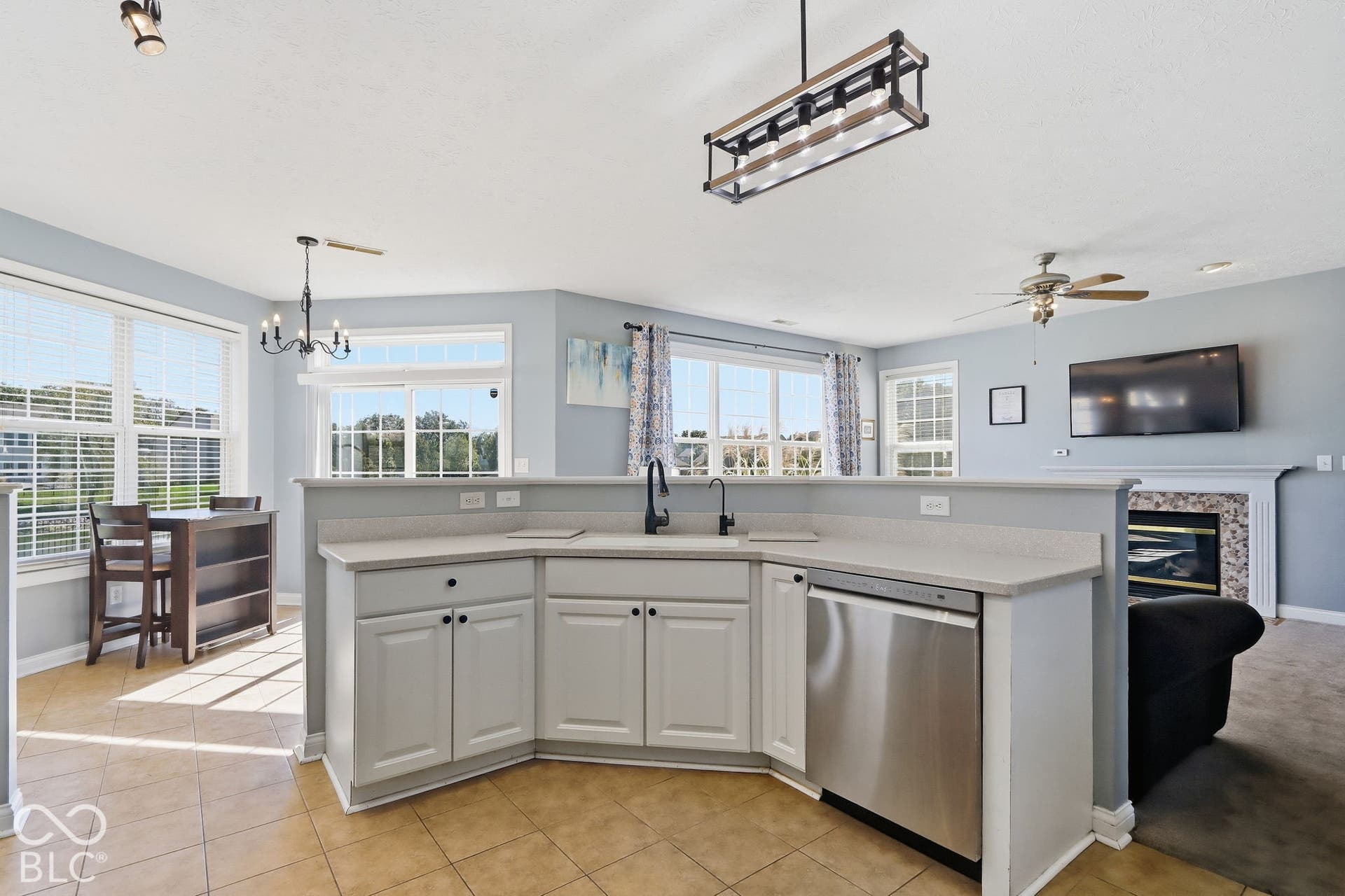 8035 Meadow Bend Lane, Indianapolis, IN 46259 Kitchen with light-toned cabinetry, stainless steel dishwasher, and a black faucet