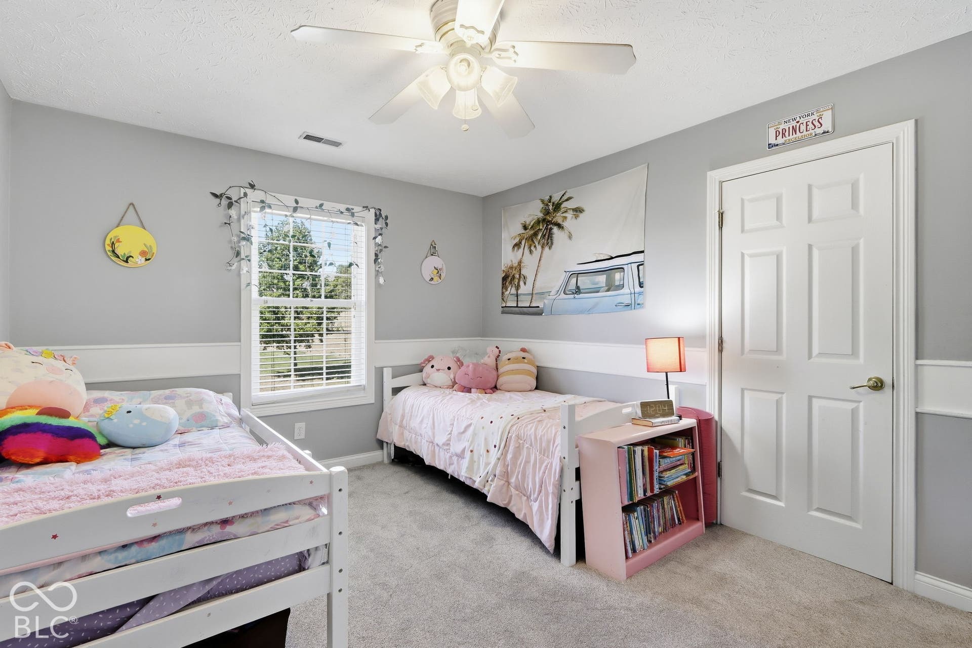 8035 Meadow Bend Lane, Indianapolis, IN 46259 Recessed window with blinds, overhead ceiling fan, light gray wall paint, white interior door with brass hardware, and white chair rail molding