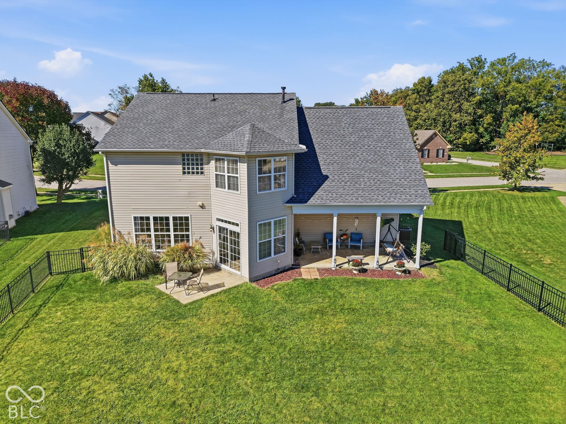 8035 Meadow Bend Lane, Indianapolis, IN 46259 Expansive green lawn with a black metal fence