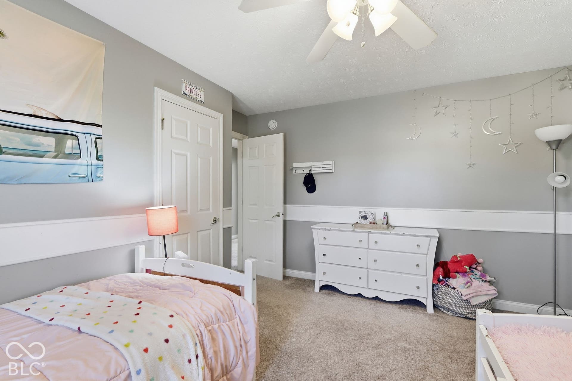 8035 Meadow Bend Lane, Indianapolis, IN 46259 Light grey walls with white chair rail molding, carpeted flooring, and a ceiling fan with integrated lighting