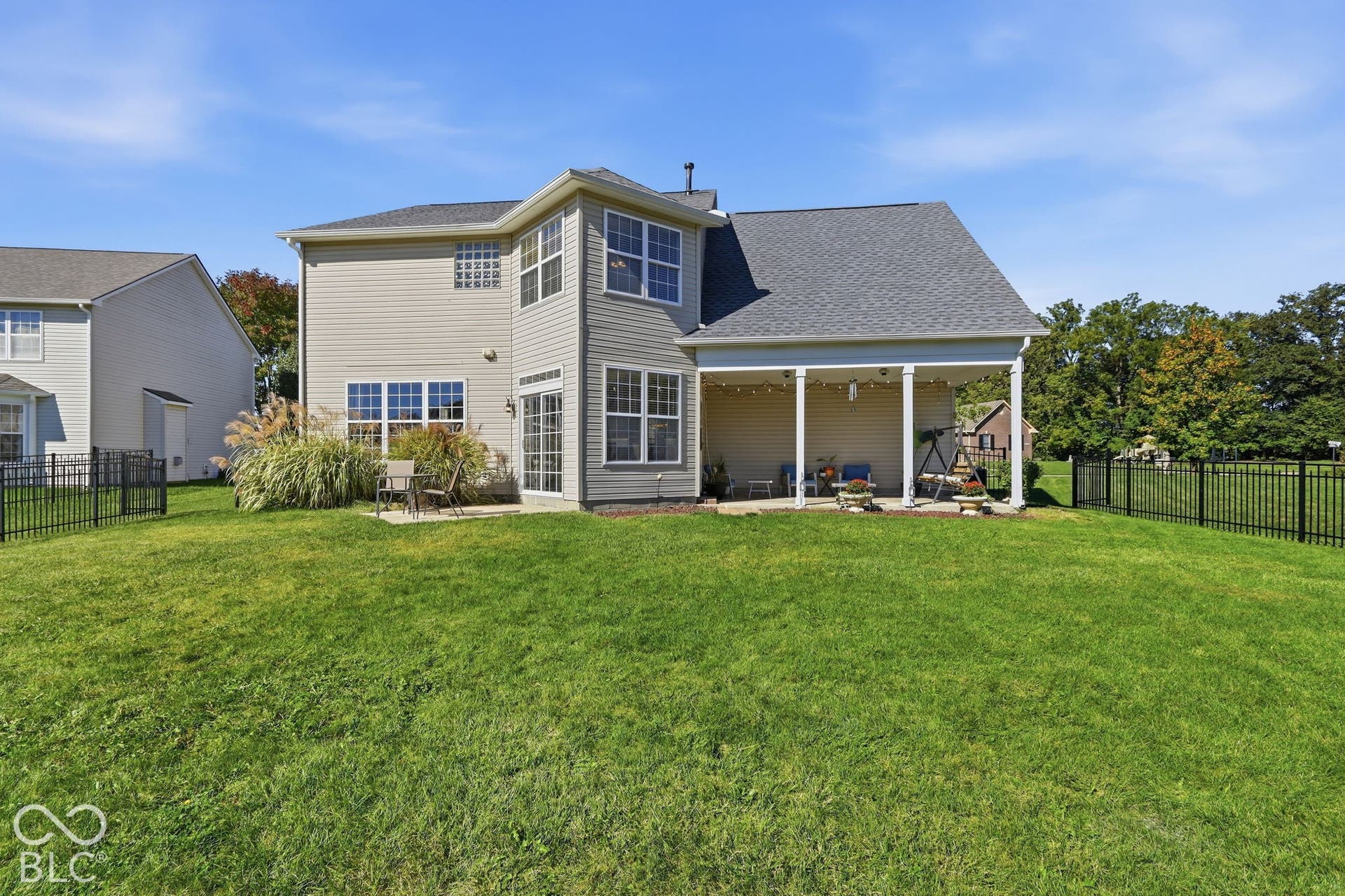 8035 Meadow Bend Lane, Indianapolis, IN 46259 Expansive backyard, .26 acre lot with a covered patio, additional concrete patio, and black metal fencing