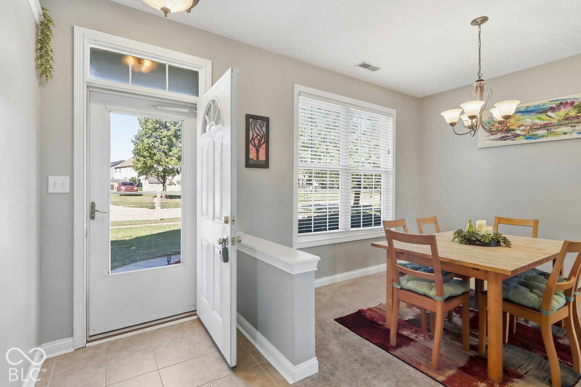 8035 Meadow Bend Lane, Indianapolis, IN 46259 Entryway with tile flooring, transom window, and a white door with an arched glass insert
