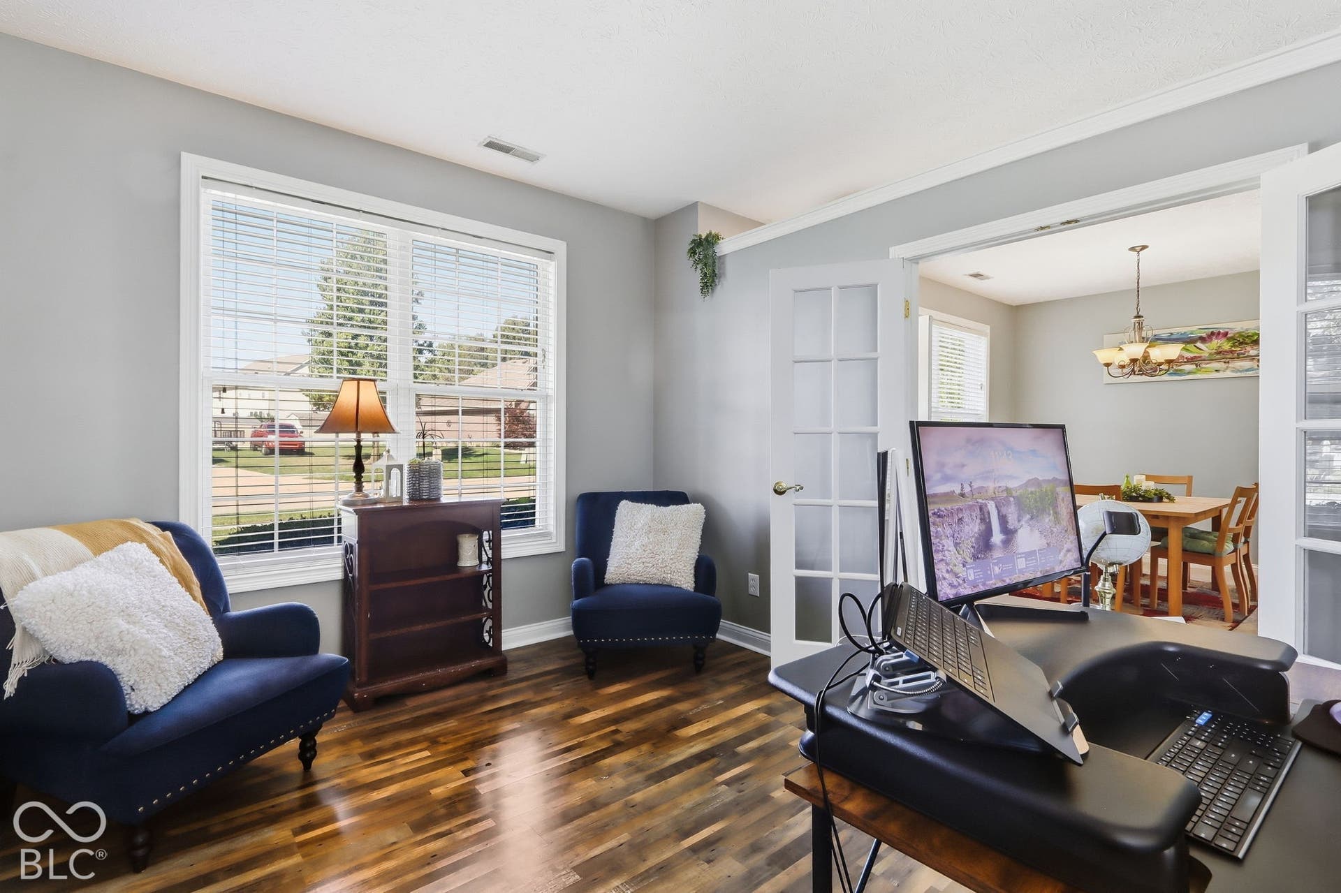 8035 Meadow Bend Lane, Indianapolis, IN 46259 Wood-finish flooring, white trim, and a large window with blinds