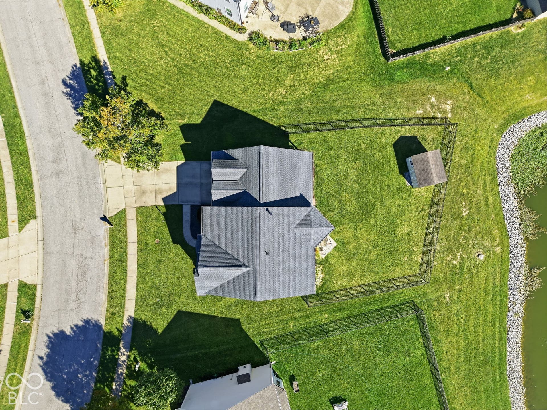 8035 Meadow Bend Lane, Indianapolis, IN 46259 Property featuring a multi-gabled roof, concrete driveway, fenced yard, and a storage shed