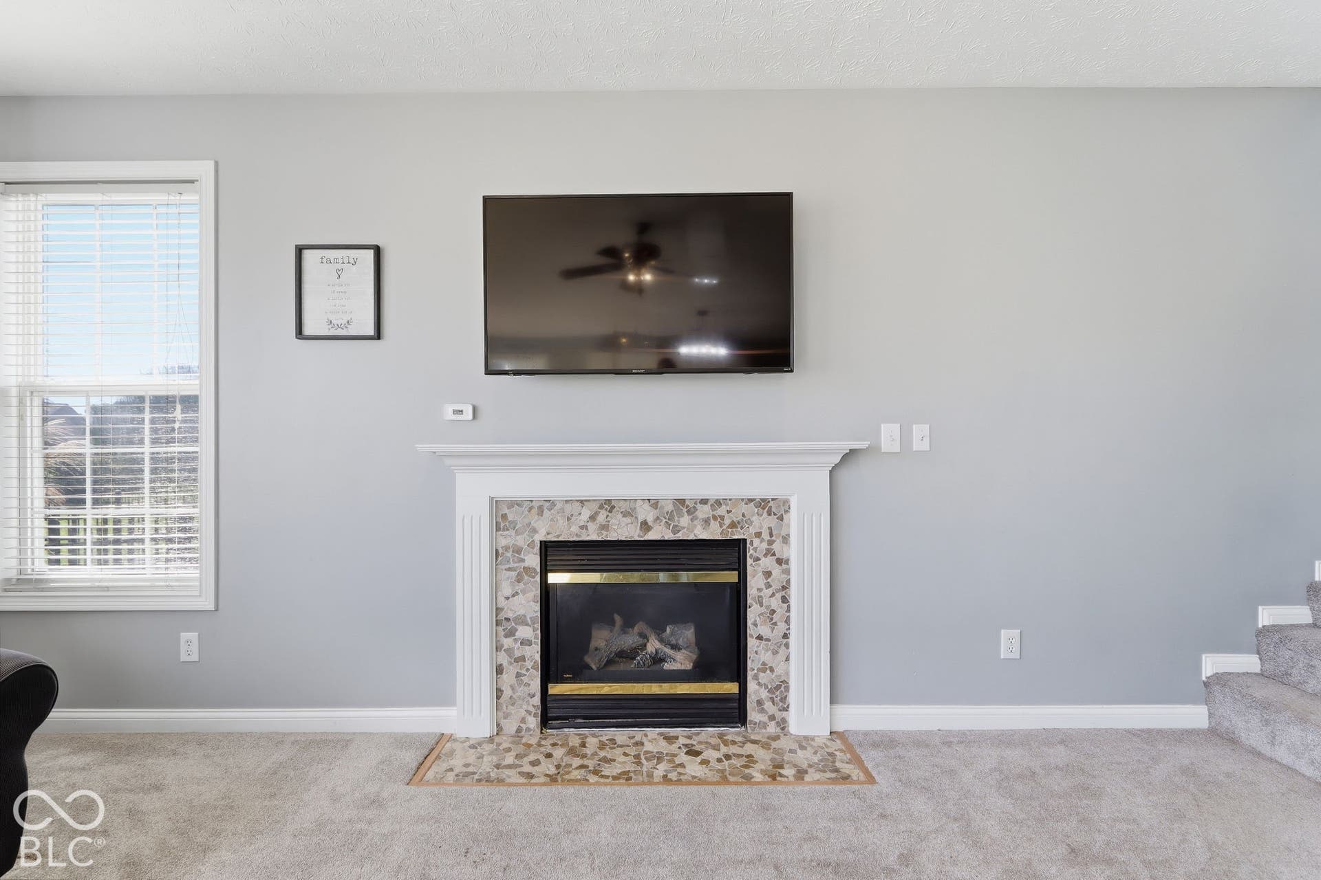 8035 Meadow Bend Lane, Indianapolis, IN 46259 Gas fireplace with a decorative tile surround and hearth