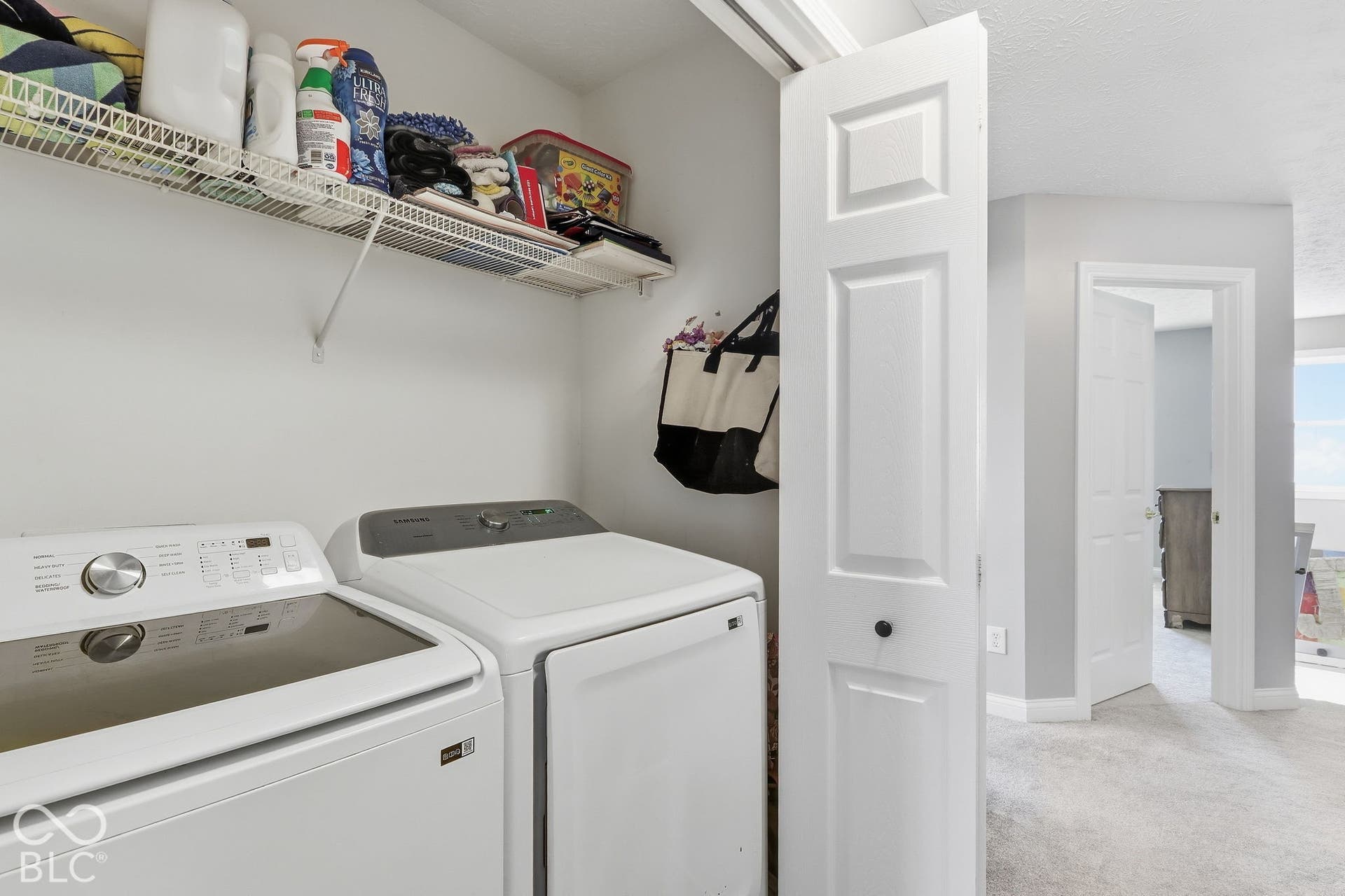 8035 Meadow Bend Lane, Indianapolis, IN 46259 Dedicated laundry area on 2nd level of home with white walls and overhead shelving