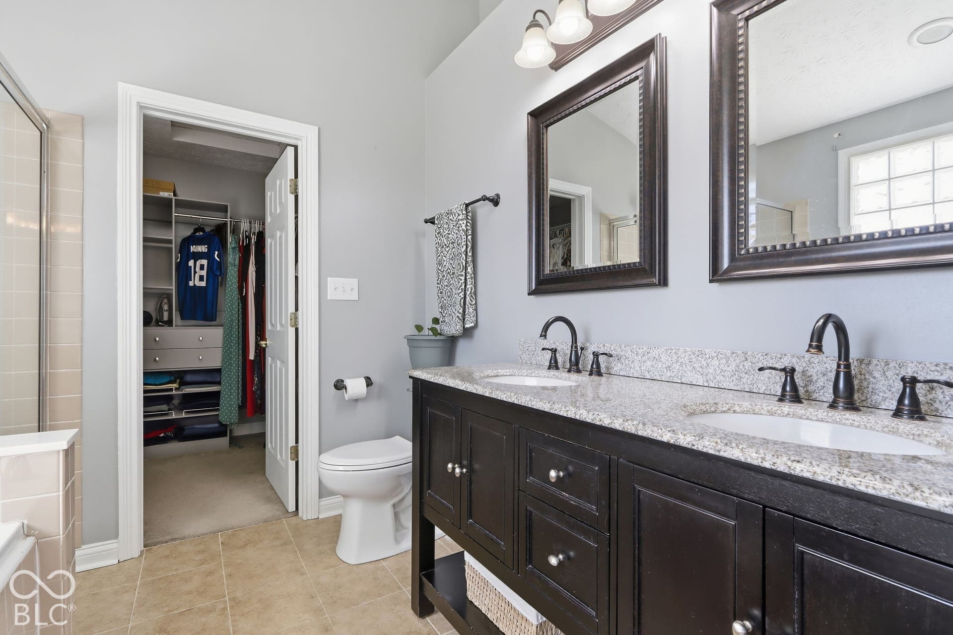 8035 Meadow Bend Lane, Indianapolis, IN 46259 Double vanity with stone countertop and individual framed mirrors