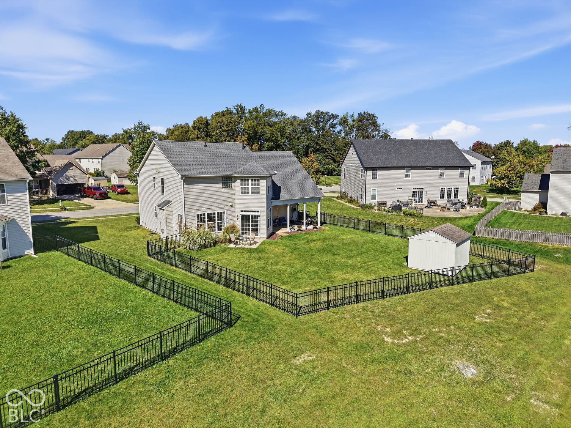 8035 Meadow Bend Lane, Indianapolis, IN 46259 Expansive backyard with a manicured lawn, full perimeter fencing, and a dedicated storage shed