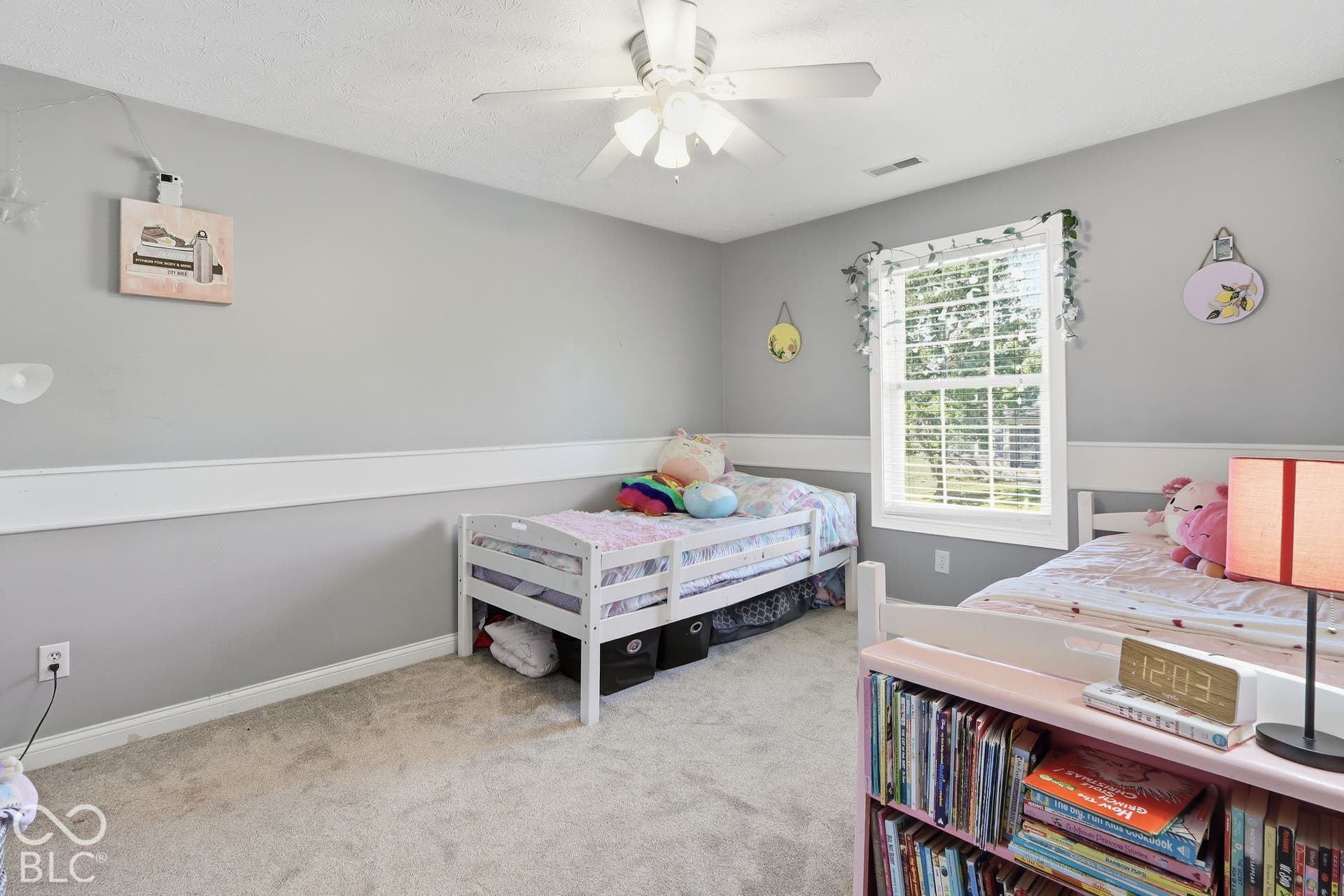 8035 Meadow Bend Lane, Indianapolis, IN 46259 Neutral wall paint, ceiling fan with integrated lighting, window with blinds, and light-colored carpeting
