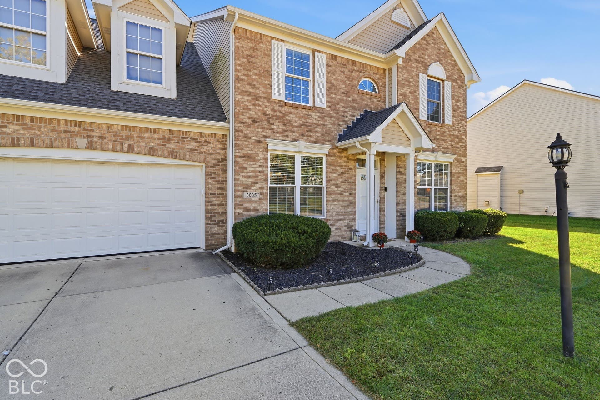 8035 Meadow Bend Lane, Indianapolis, IN 46259 Brick facade two-story residence featuring a covered entry and a two-car garage