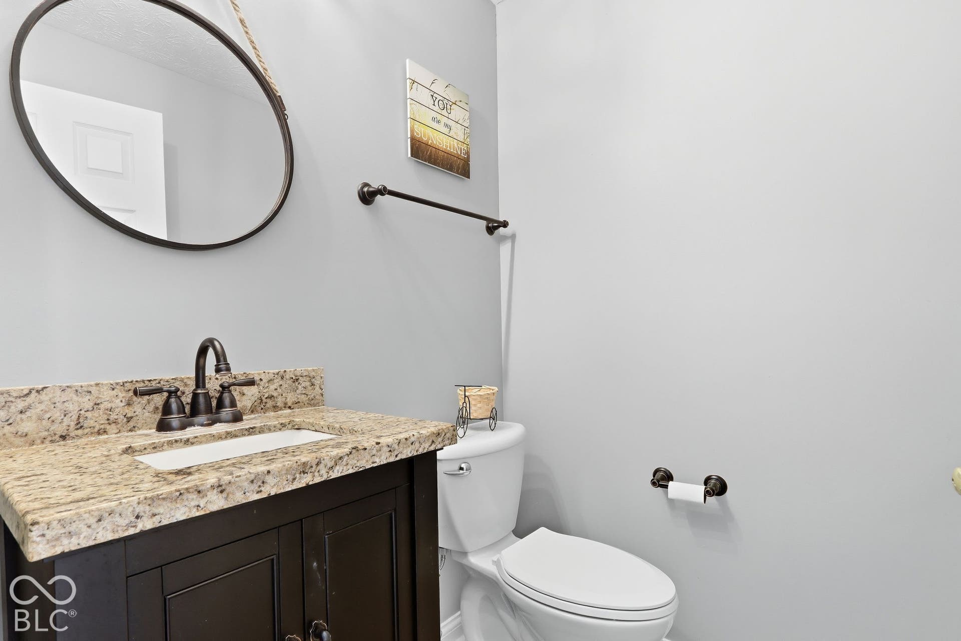8035 Meadow Bend Lane, Indianapolis, IN 46259 Vanity with a granite countertop, undermount sink, and dark bronze-finish fixtures