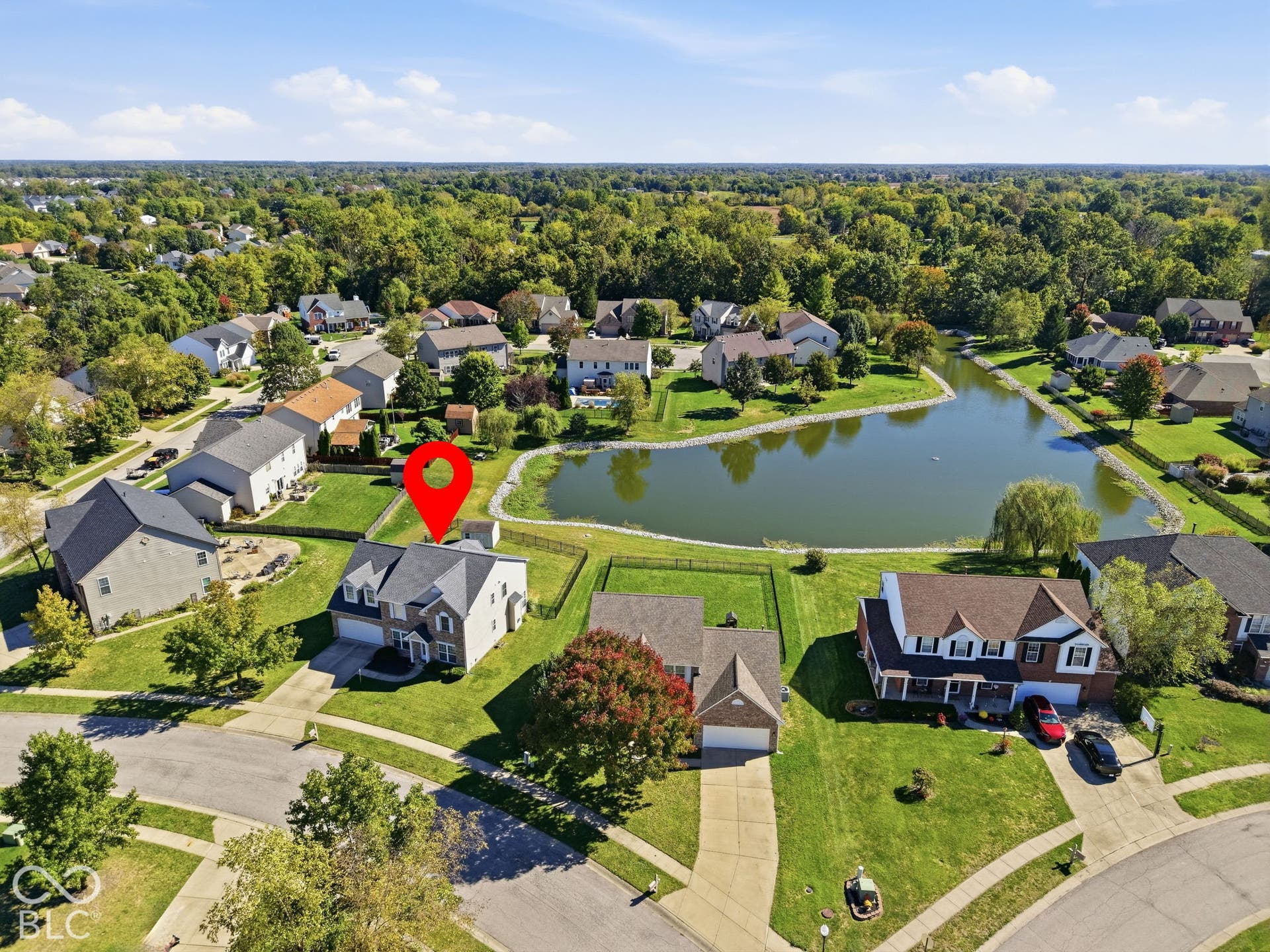 8035 Meadow Bend Lane, Indianapolis, IN 46259 Manicured lawns, mature trees, and a tranquil pond, all surrounded by a developed residential area