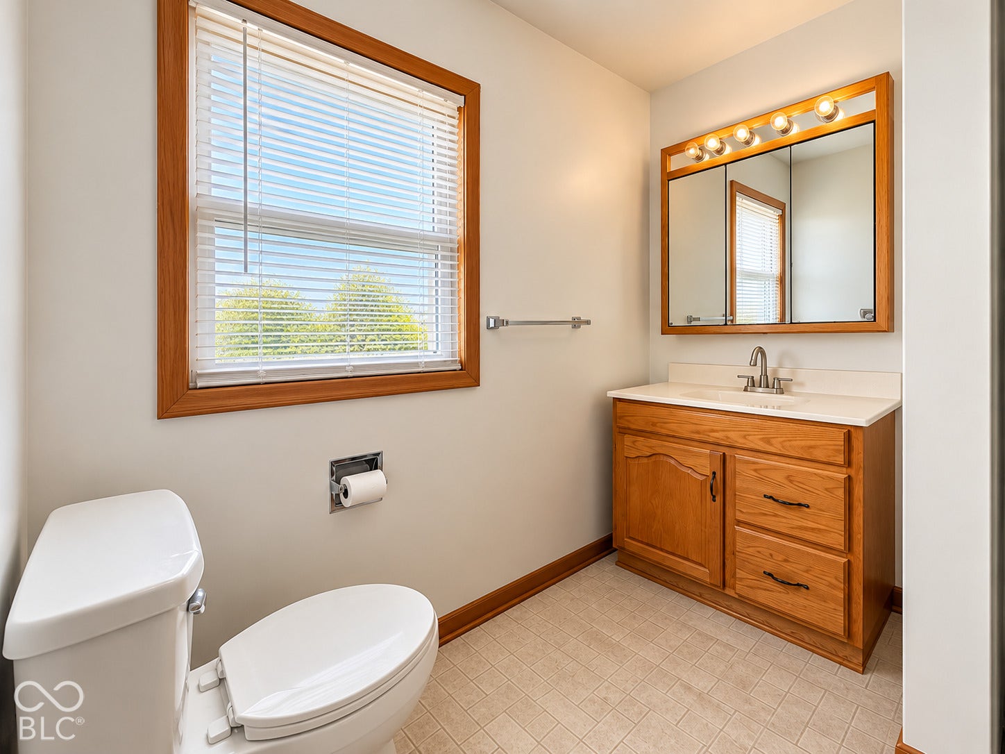 Wood-finish vanity with white countertop and integrated sink