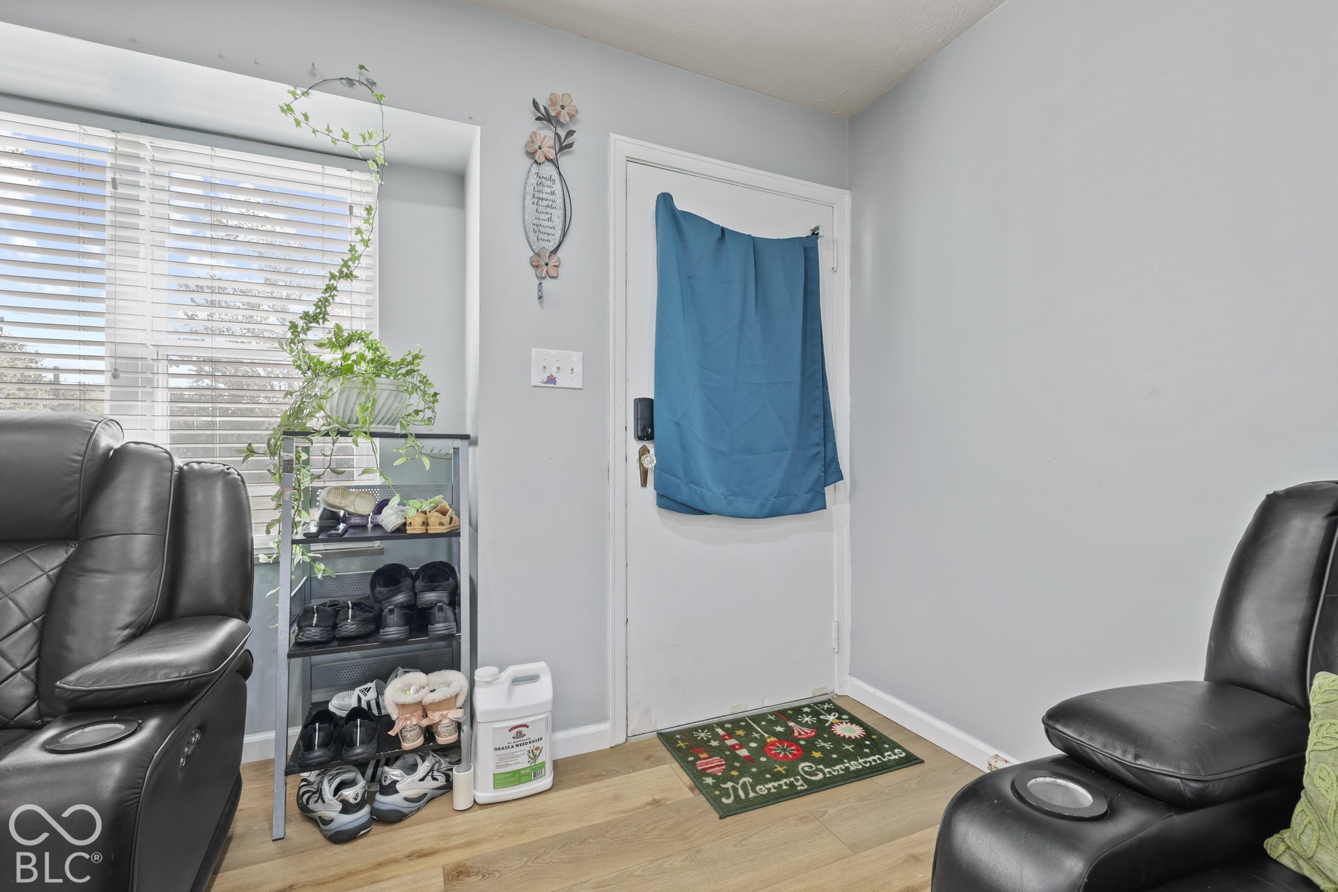 Wood-finish flooring with a light gray wall color, and white trim