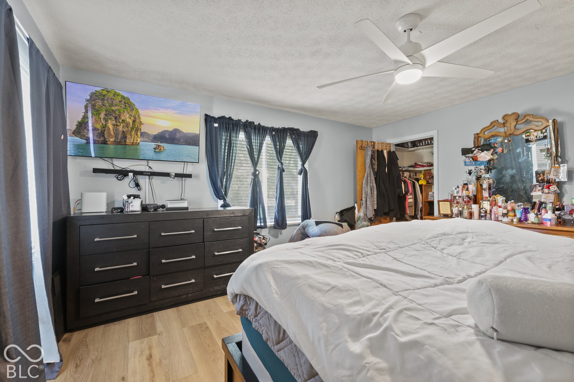 Wood-finish flooring, ceiling fan, and a built-in closet