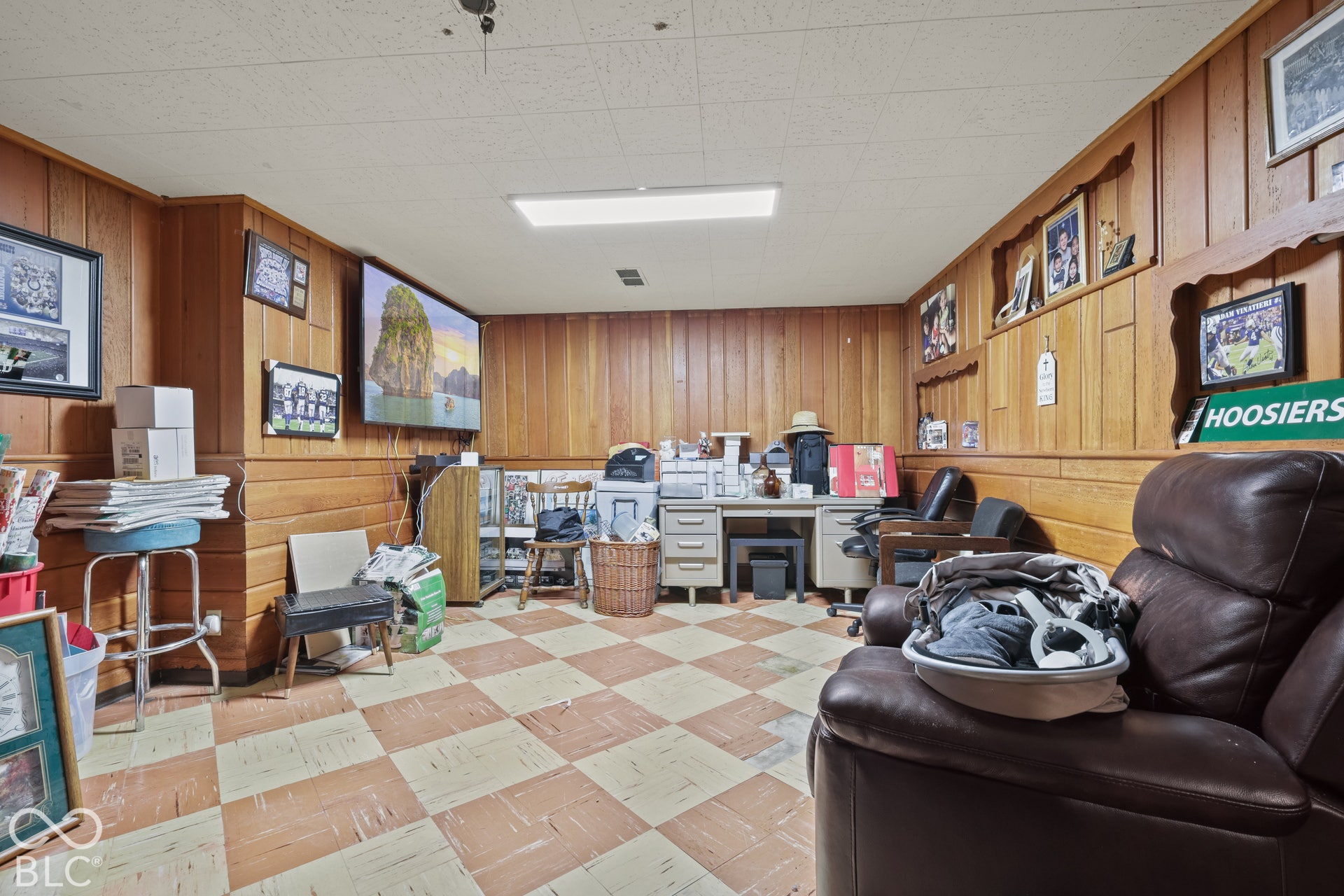 Wood paneling, drop ceiling, checkered flooring, recessed lighting