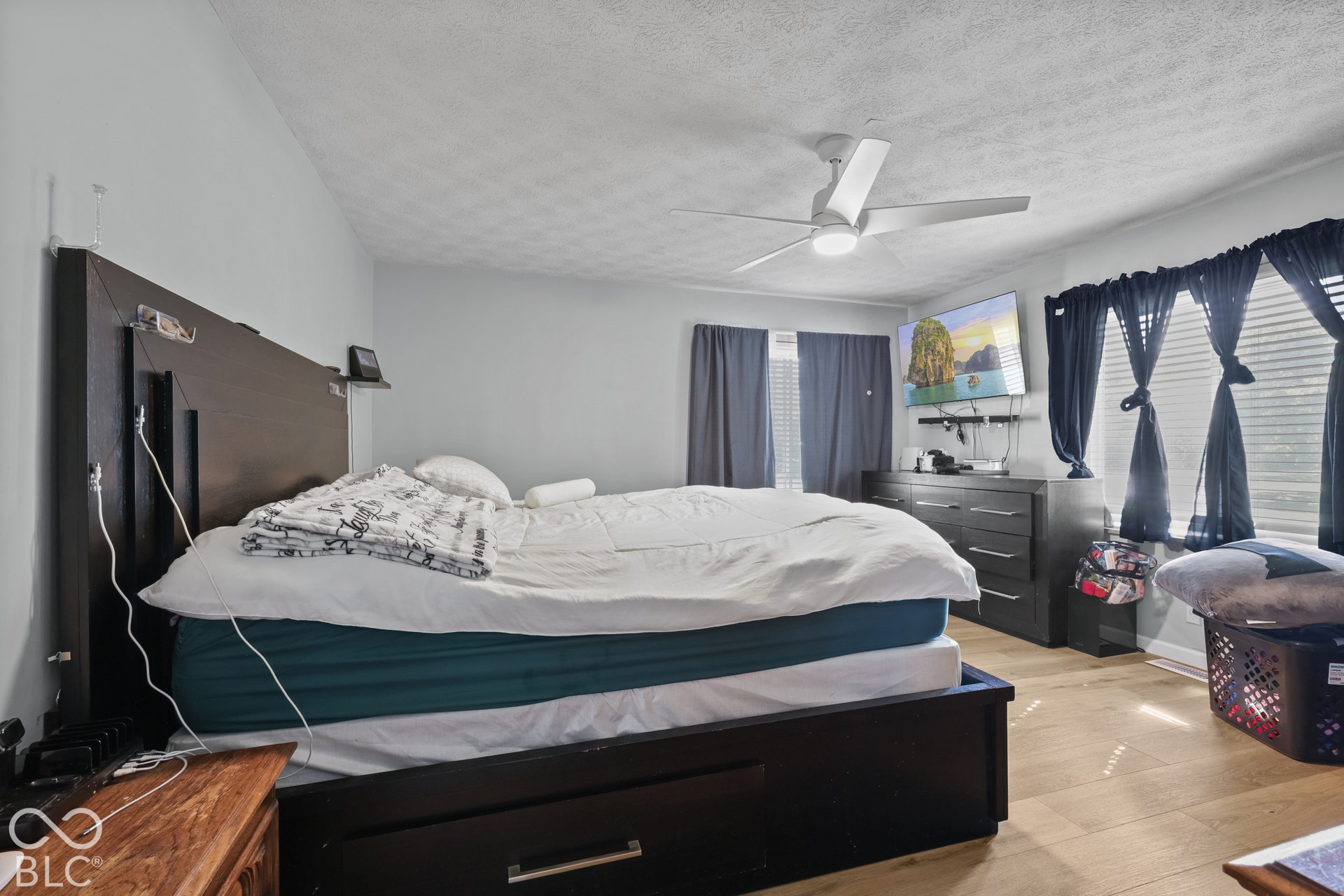 Wood-finish flooring with a ceiling fan overhead