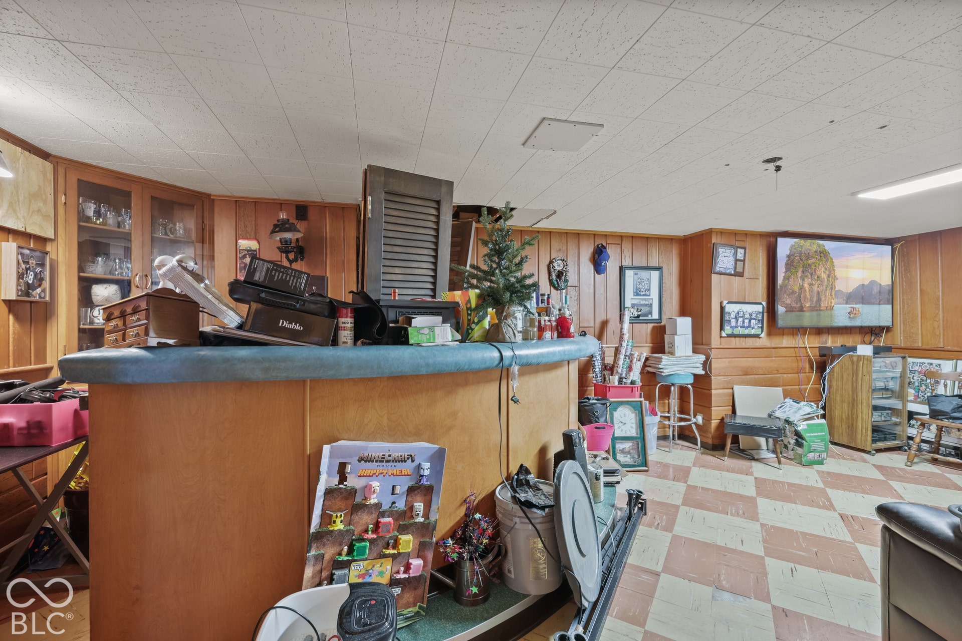 Additional contentThe image shows an interior space with significant clutter, personal items, and furnishings that obscure the permanent architectural features
