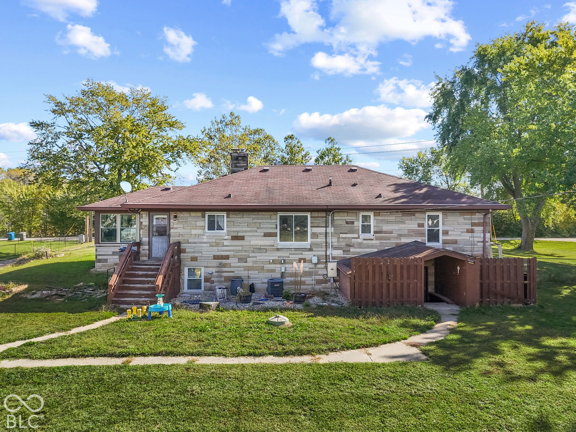 Stone veneer exterior with a sloped roof