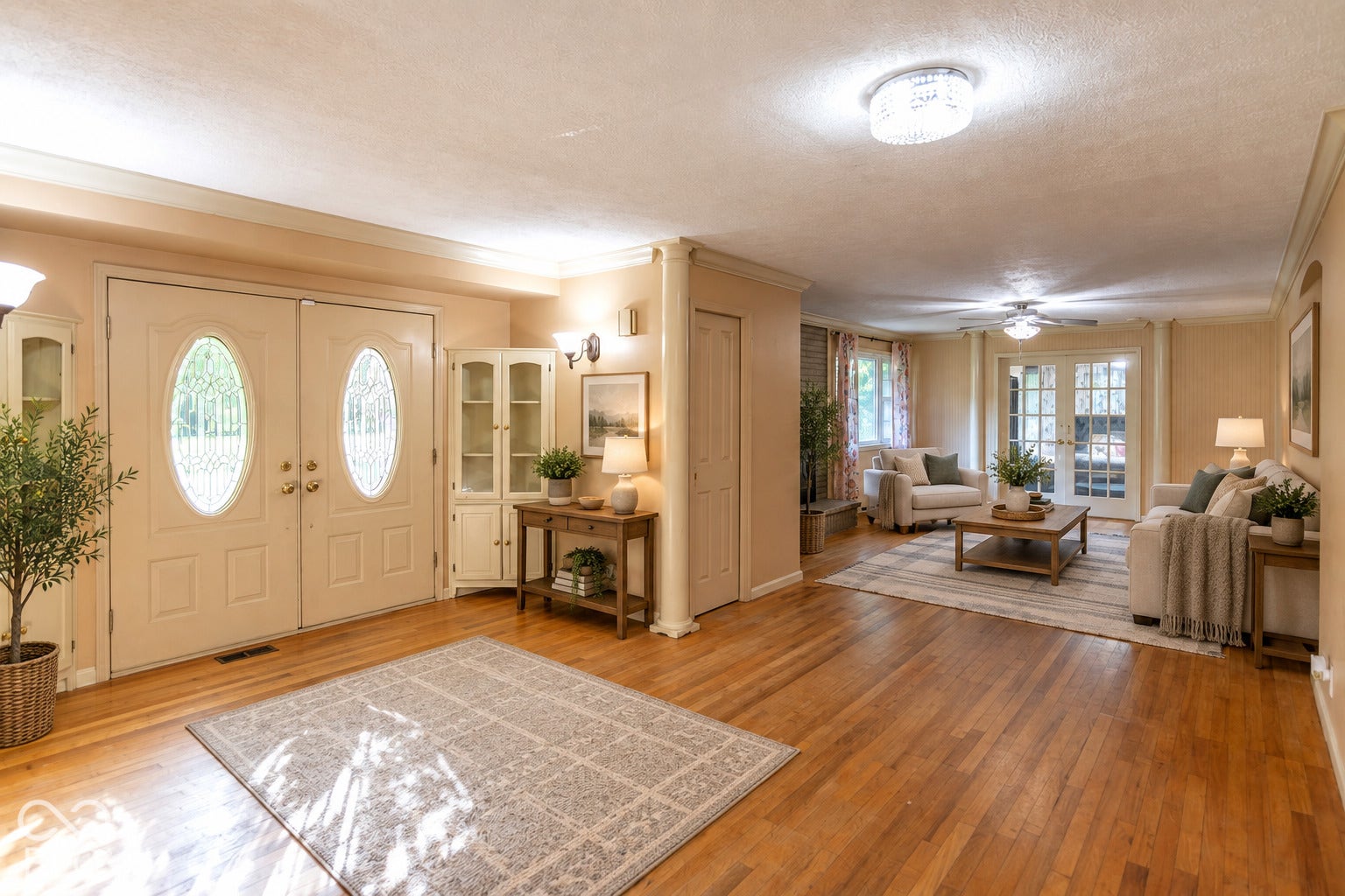 Virtually Altered - Wood-finish flooring throughout, double entry doors with decorative glass inserts, and a chandelier lighting fixture