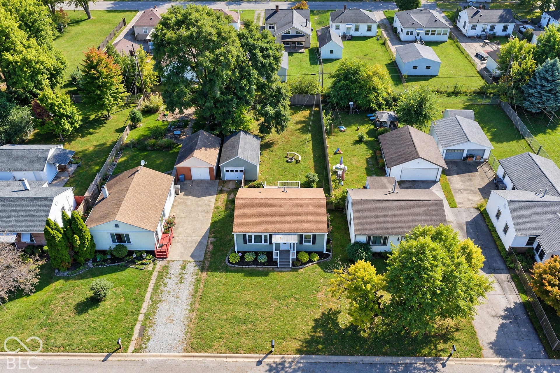 Virtually Altered - Two detached garages, two driveways, and a fenced backyard
