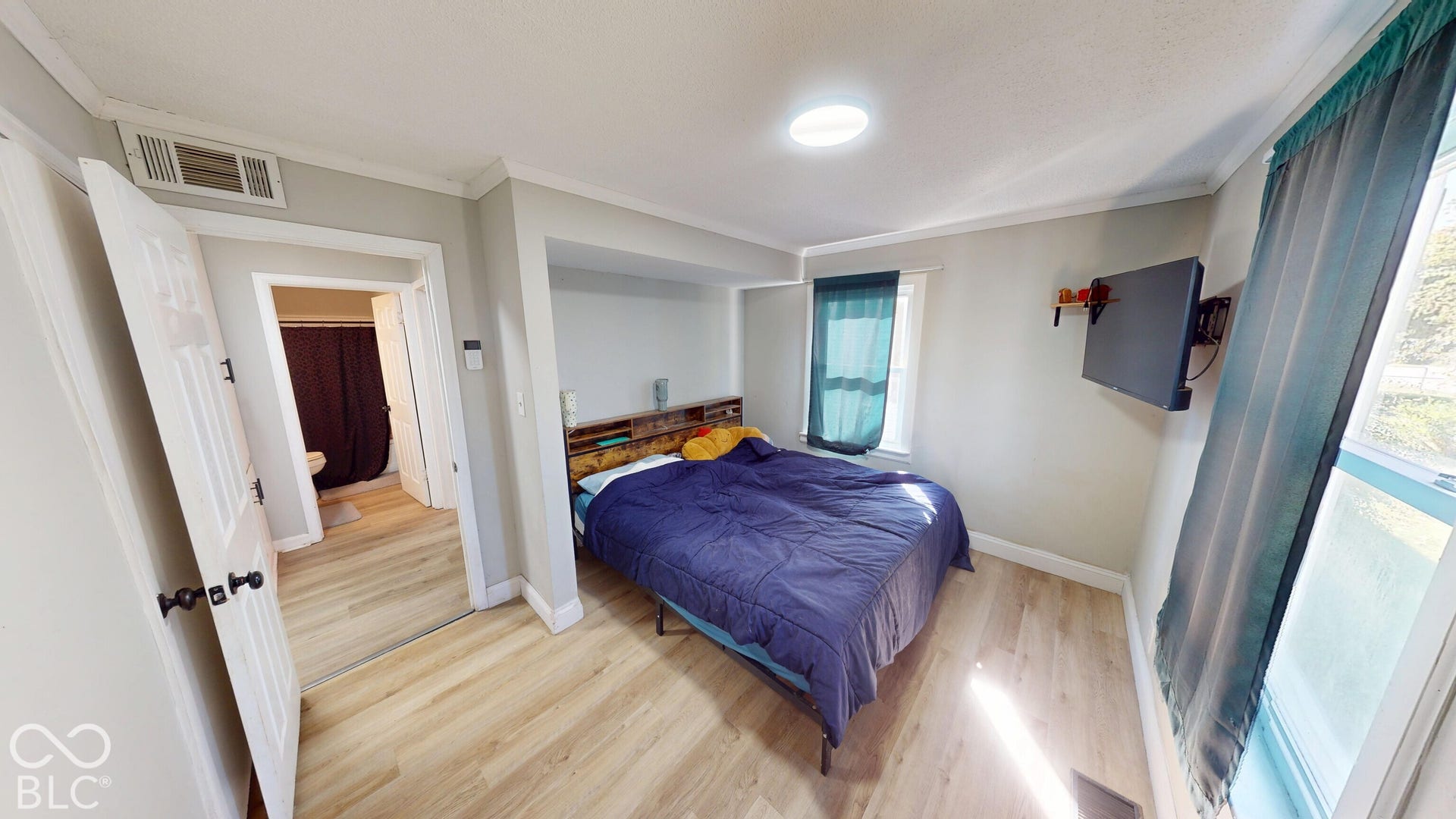 Wood-finish flooring throughout, recessed ceiling light, and built-in alcove
