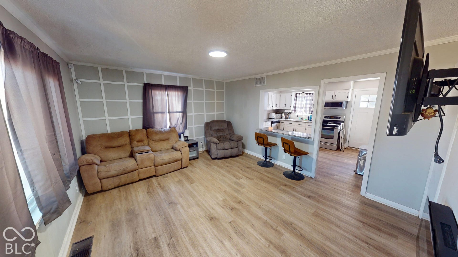 Wood-finish flooring throughout, with a recessed ceiling light