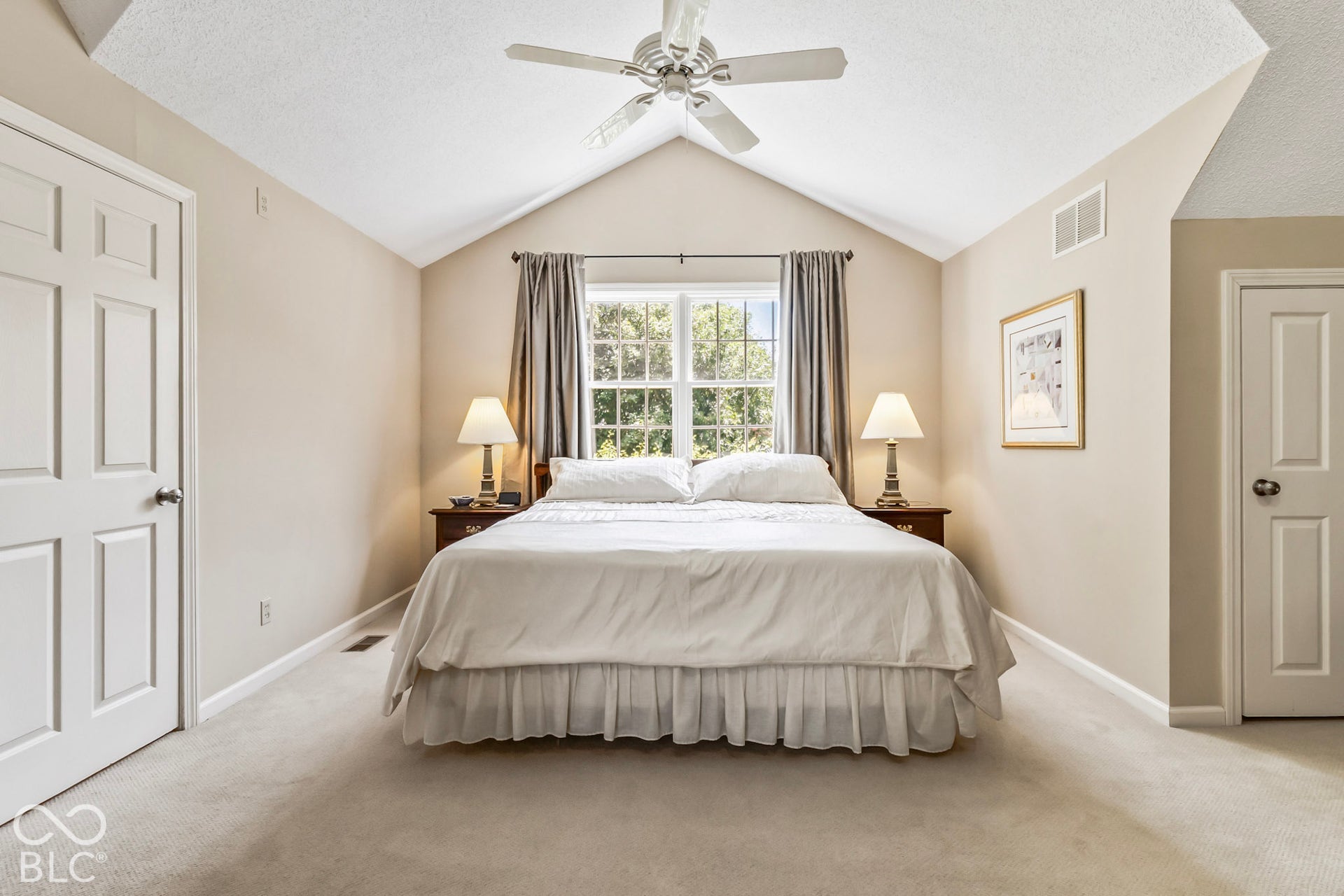 10954 N County Road 150 Road E, Pittsboro, IN 46167 Vaulted ceiling featuring a central white cooling fan, neutral wall tones, multi-pane window, and dual interior doors