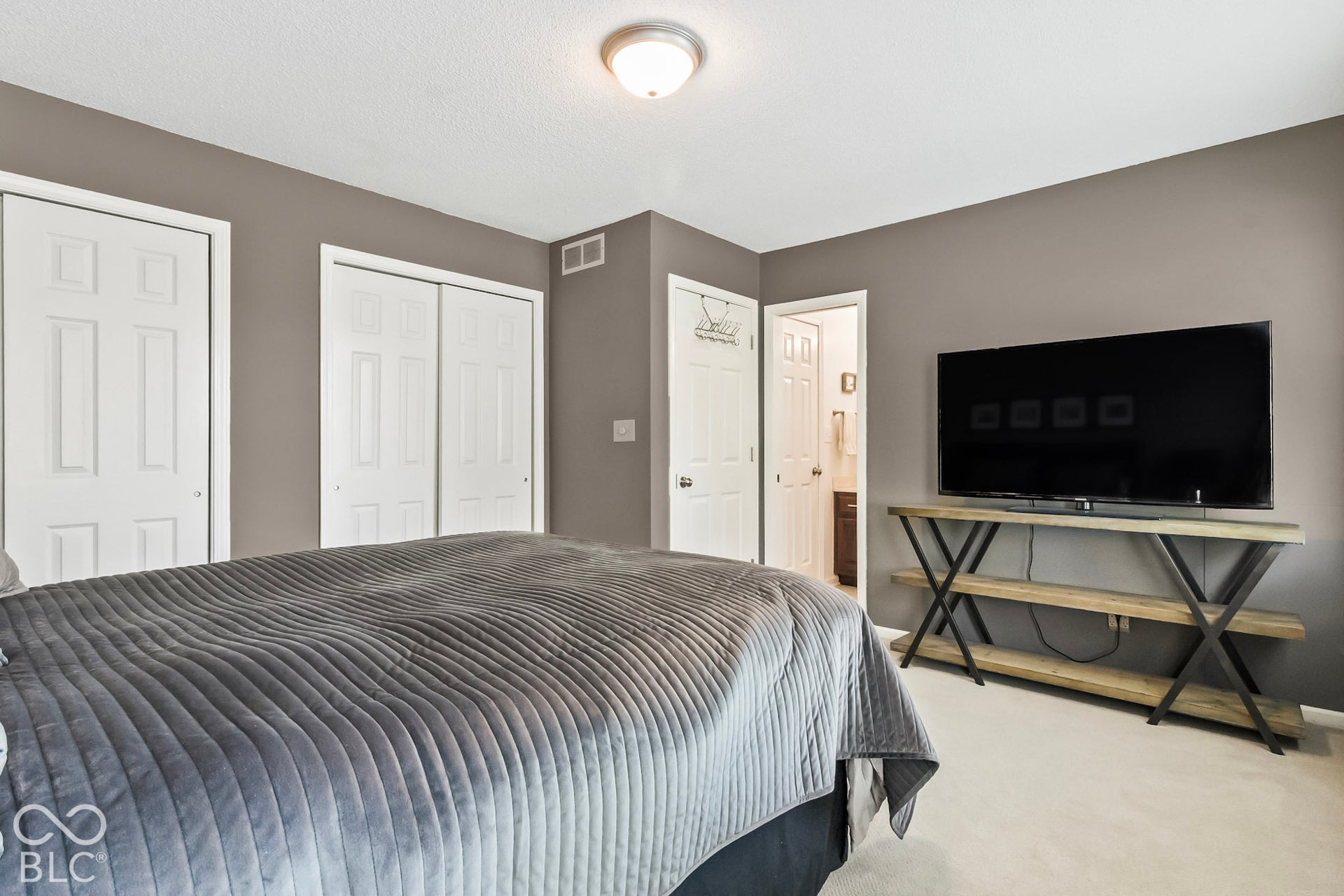 10954 N County Road 150 Road E, Pittsboro, IN 46167 Room with neutral wall finish, light-toned carpeting, and multiple white multi-panel doors, including a double-door closet