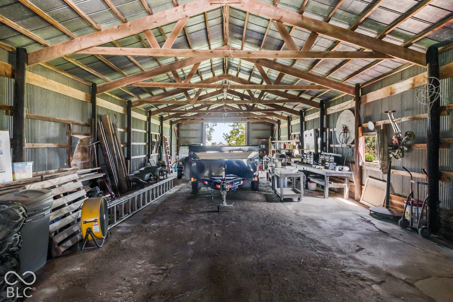 10954 N County Road 150 Road E, Pittsboro, IN 46167 Outbuilding featuring a concrete floor, exposed wooden truss ceiling, and corrugated metal wall panels