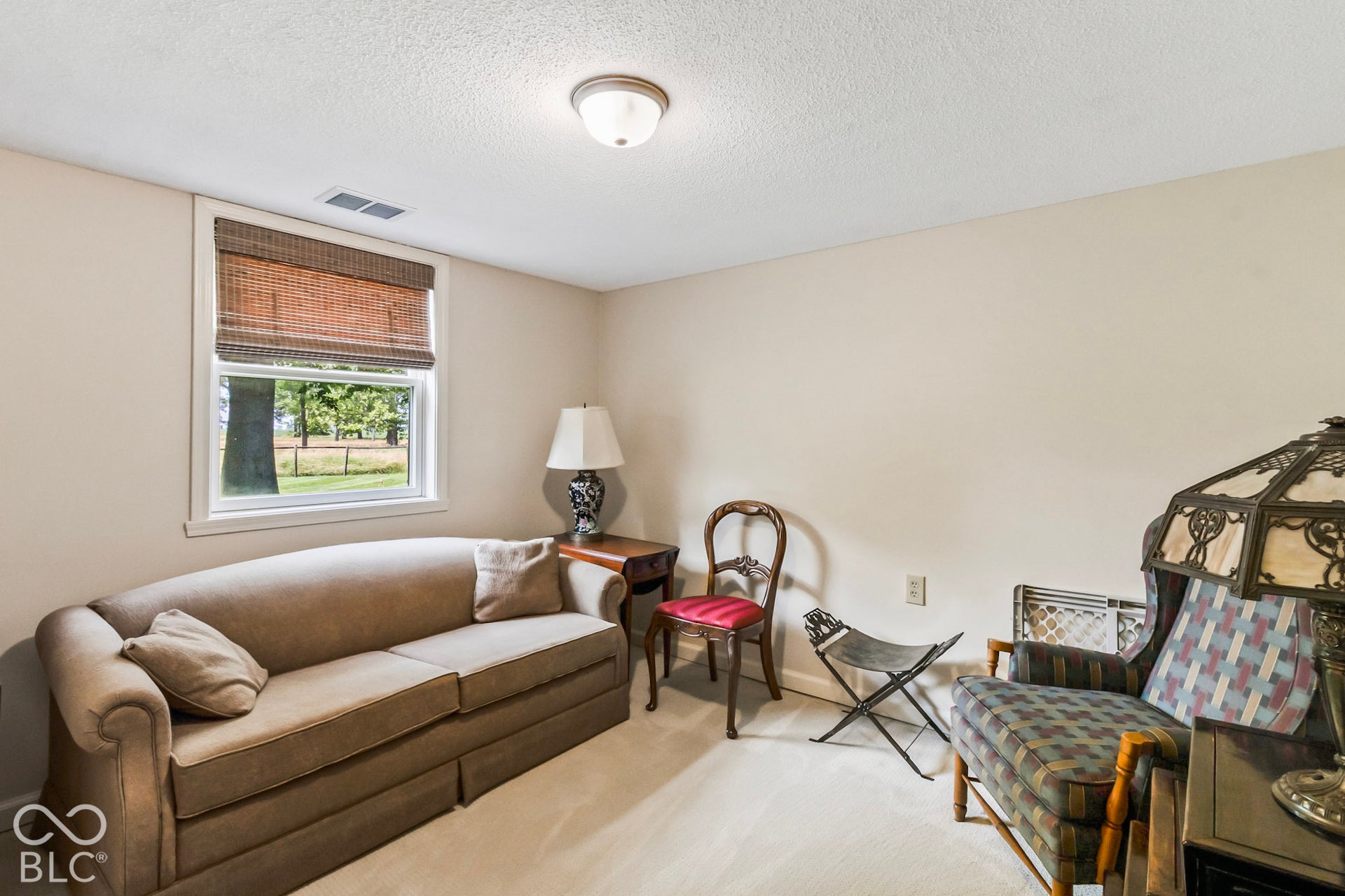 10954 N County Road 150 Road E, Pittsboro, IN 46167 Room featuring neutral wall tones, carpeted flooring, and a single-pane window with a woven shade