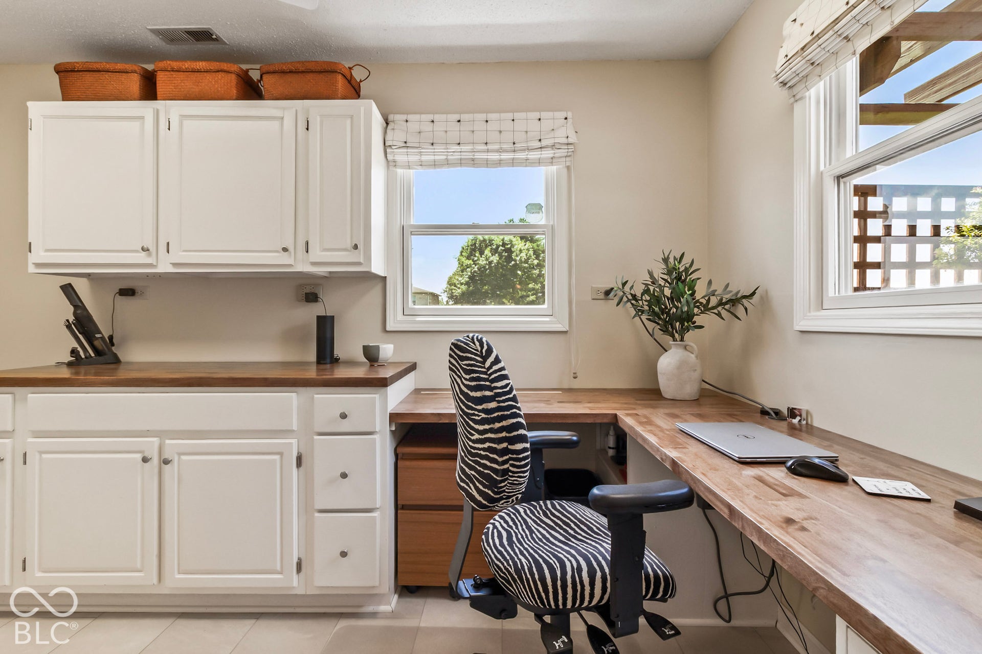10954 N County Road 150 Road E, Pittsboro, IN 46167 Built-in L-shaped wood-surface desk with integrated white cabinetry, upper storage cupboards, and tile flooring