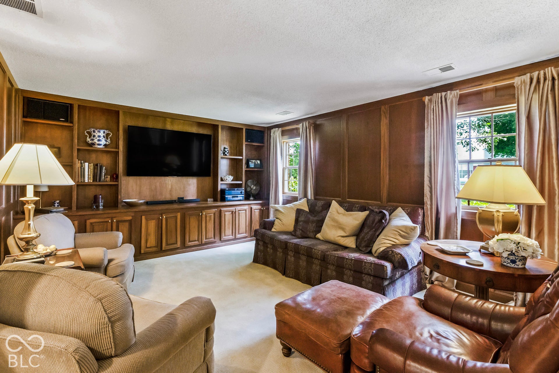 10954 N County Road 150 Road E, Pittsboro, IN 46167 Living area featuring full-wall wood paneling, custom built-in cabinetry, and multi-pane windows