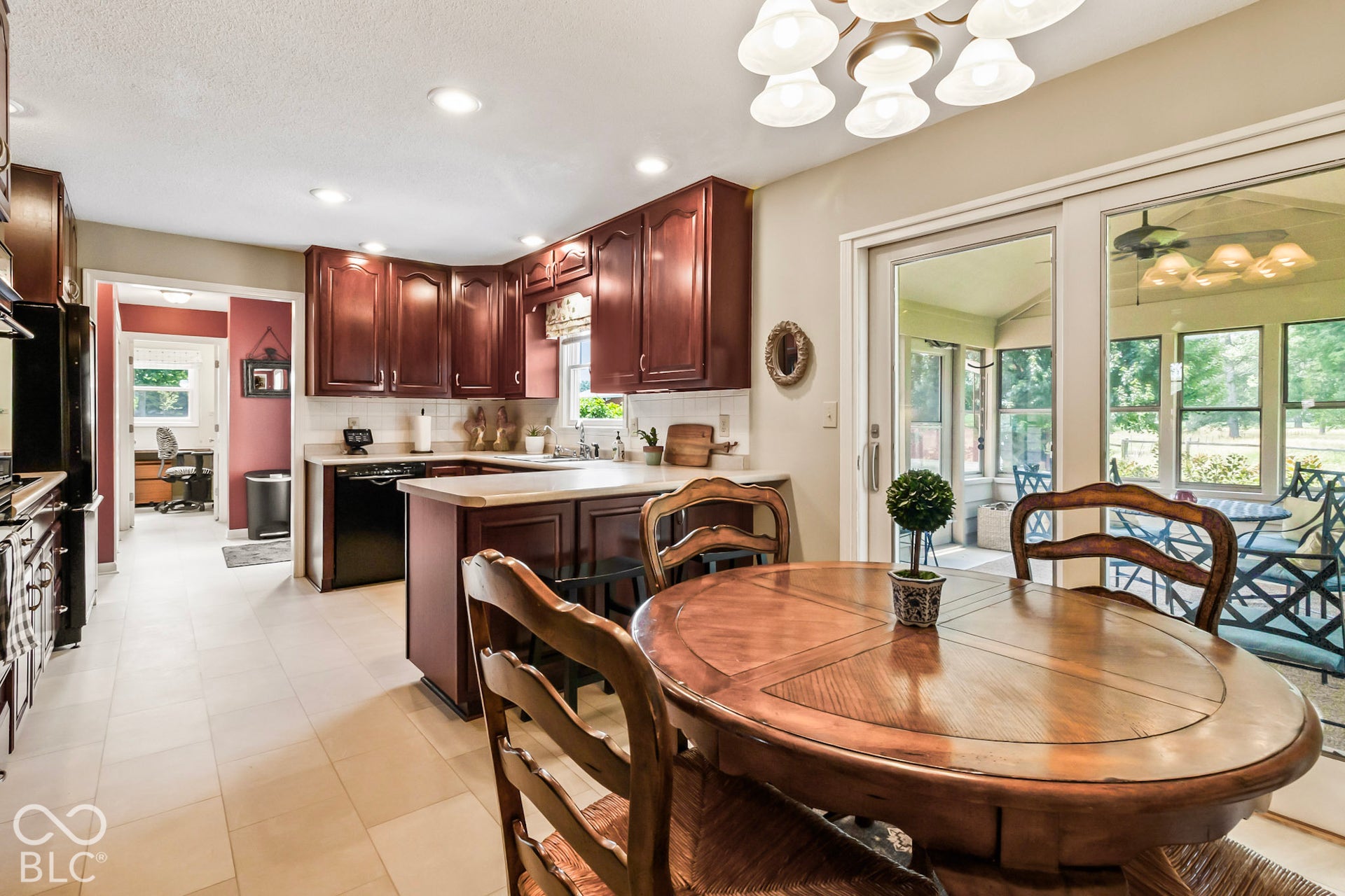 10954 N County Road 150 Road E, Pittsboro, IN 46167 Kitchen featuring cherry-finish cabinetry, solid surface countertops, tile flooring, recessed lighting, and a multi-pane sliding glass door