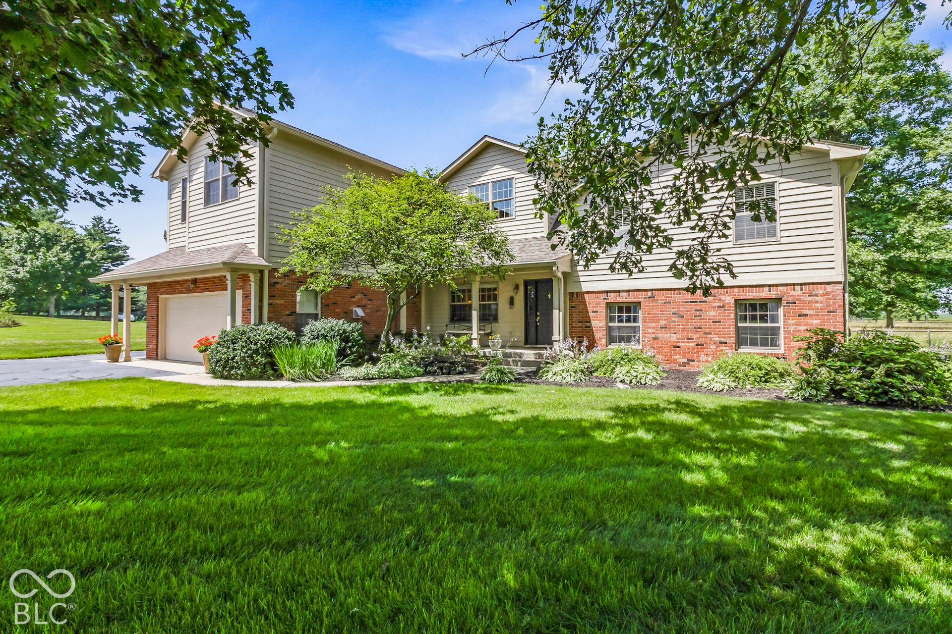 10954 N County Road 150 Road E, Pittsboro, IN 46167 Two-story exterior featuring horizontal siding, brick masonry, an attached garage, and a covered front entryway