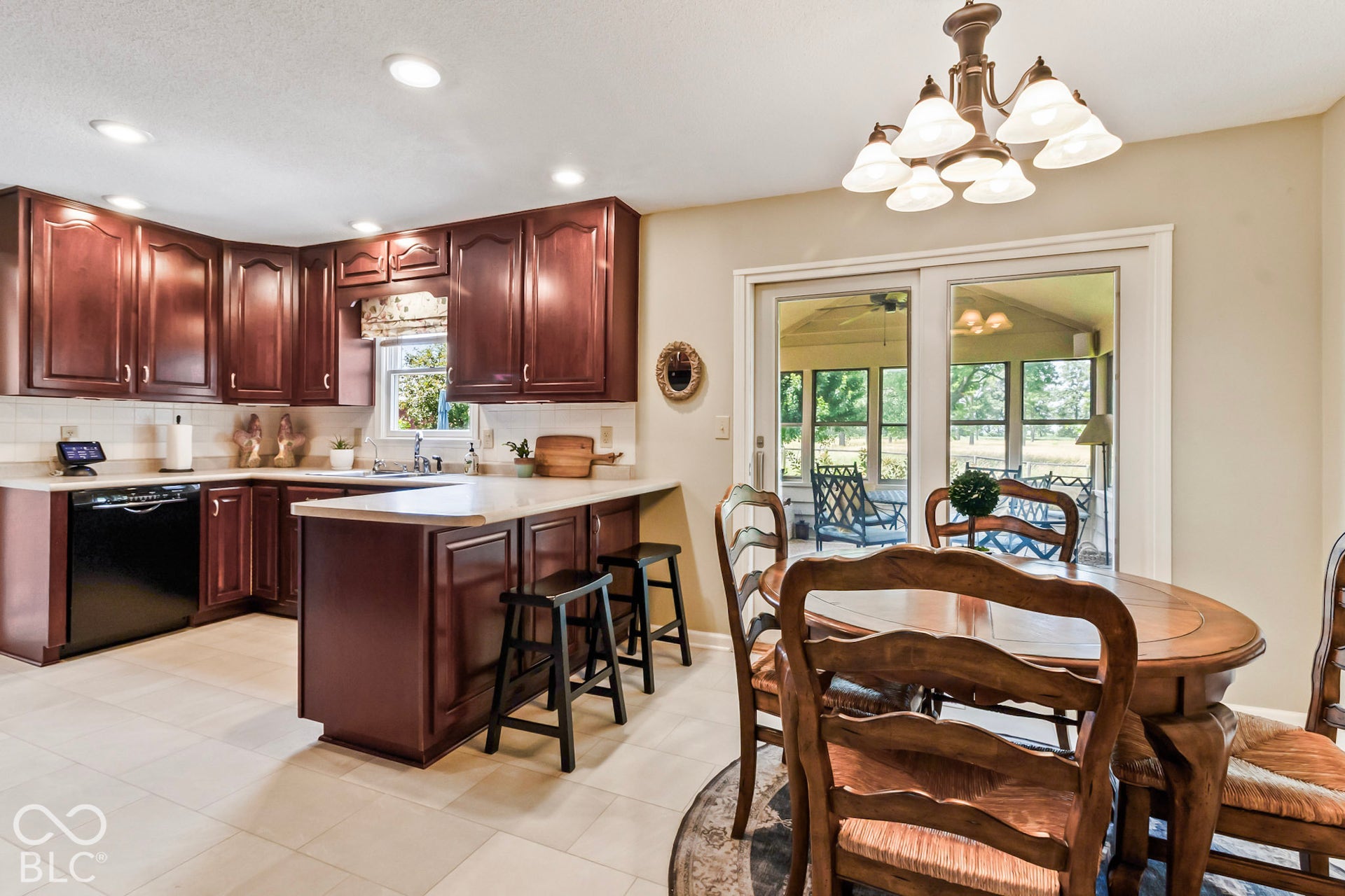 10954 N County Road 150 Road E, Pittsboro, IN 46167 Kitchen featuring dark wood cabinetry, solid surface countertops, a black dishwasher, recessed lighting, and a multi-arm chandelier