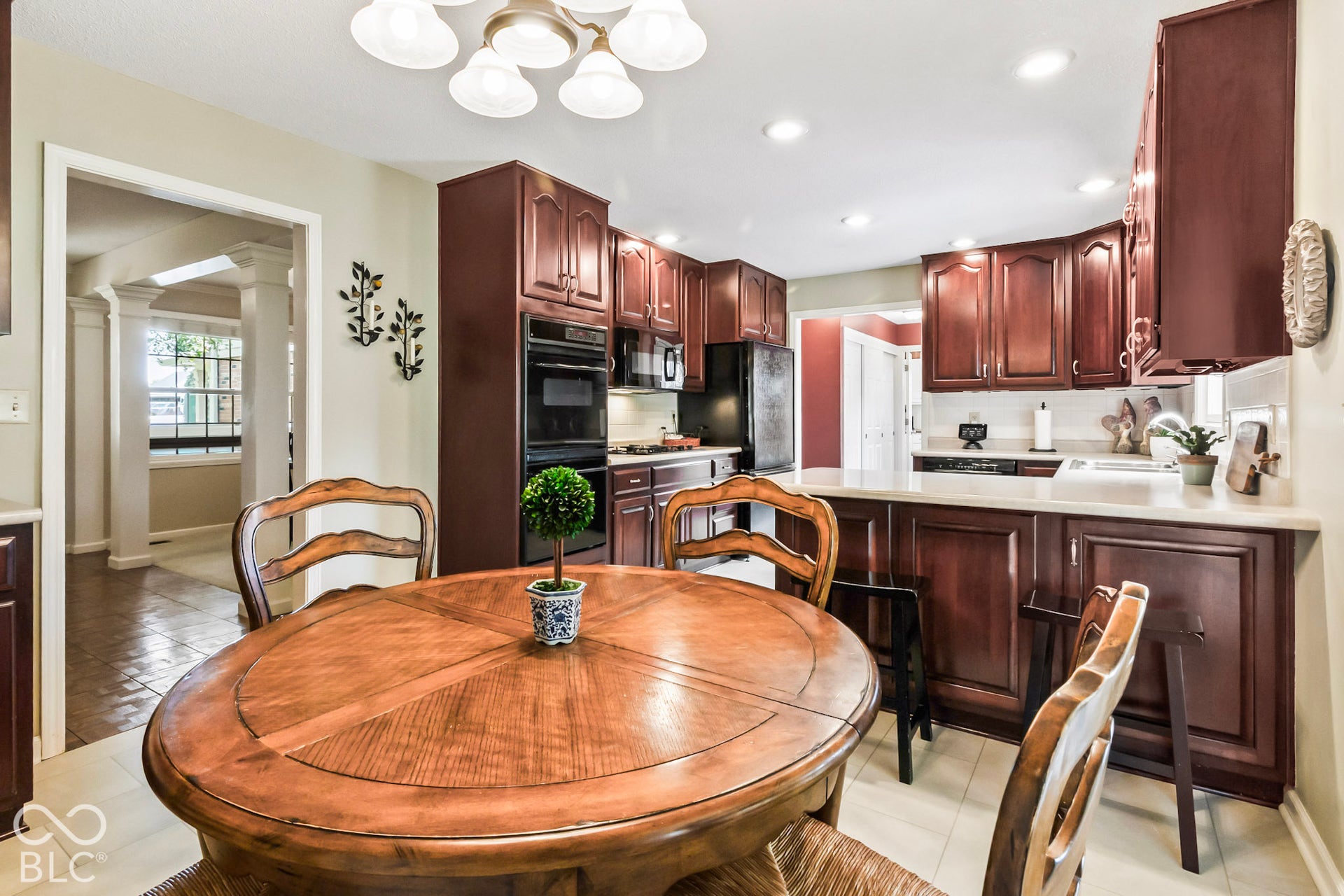 10954 N County Road 150 Road E, Pittsboro, IN 46167 Kitchen featuring dark wood cabinetry, light-toned countertops, built-in double ovens, and recessed lighting