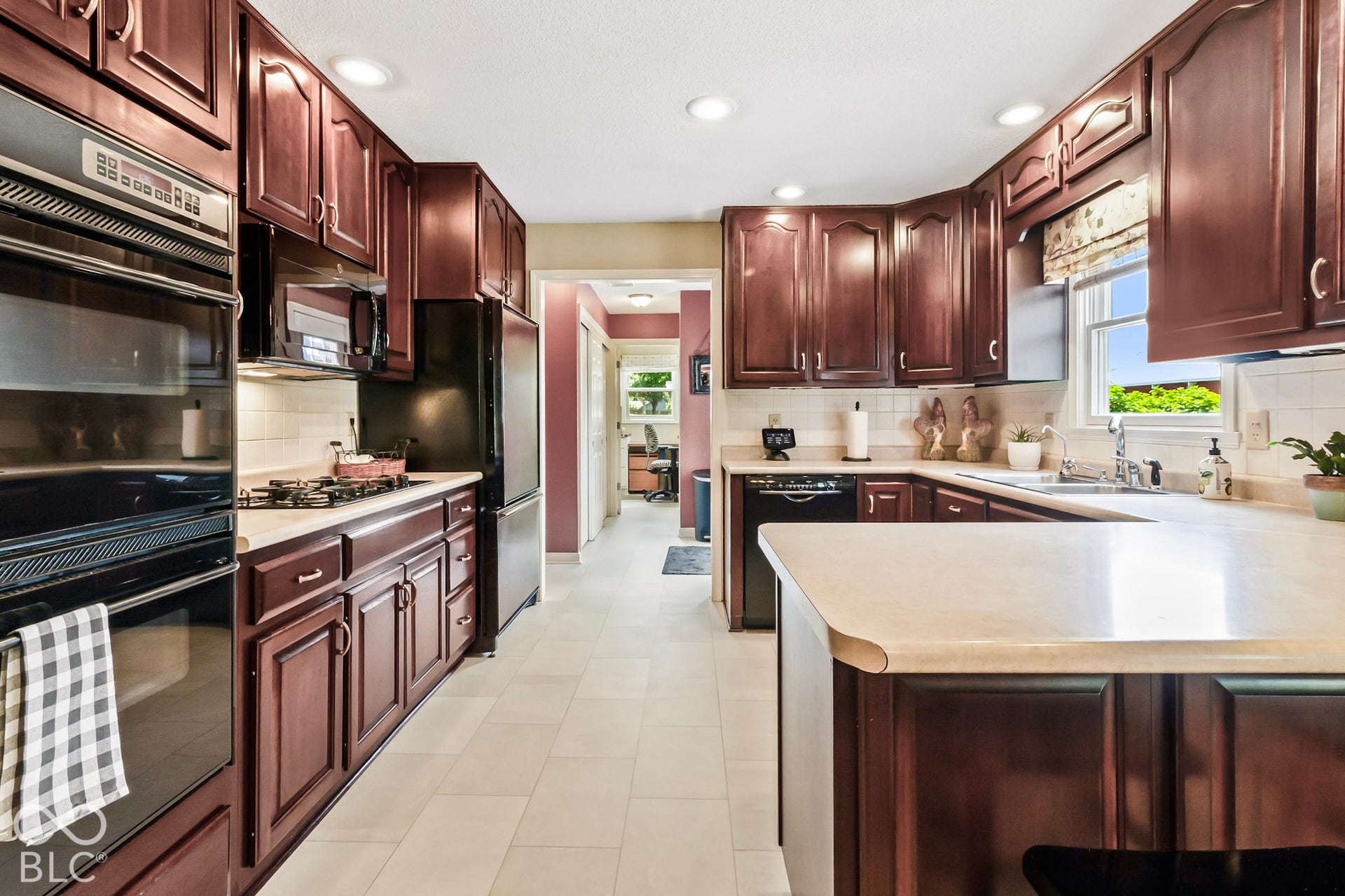 10954 N County Road 150 Road E, Pittsboro, IN 46167 Kitchen featuring dark wood cabinetry, solid surface countertops, tile flooring, and built-in double wall ovens