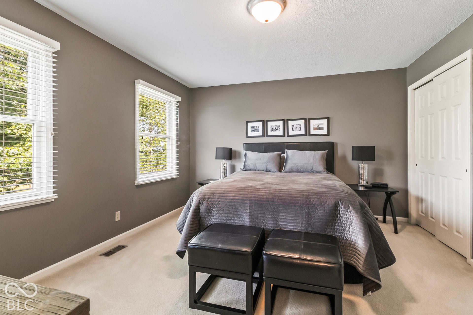 10954 N County Road 150 Road E, Pittsboro, IN 46167 Neutral wall color, dual double-hung windows with horizontal blinds, carpeted flooring, and a multi-panel sliding closet door