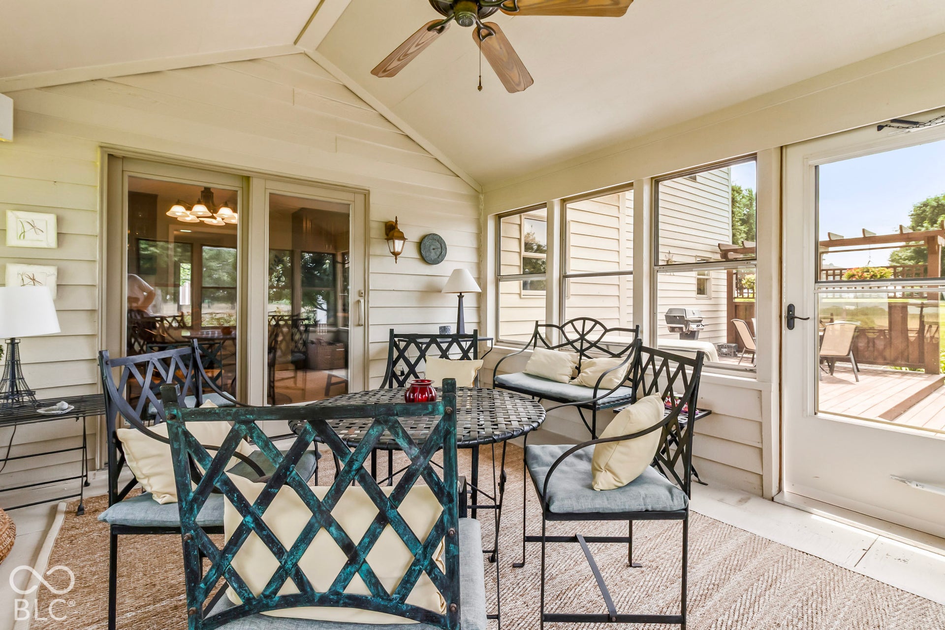 10954 N County Road 150 Road E, Pittsboro, IN 46167 Enclosed patio featuring a vaulted ceiling, ceiling fan, expansive window walls, and glass-paned sliding doors