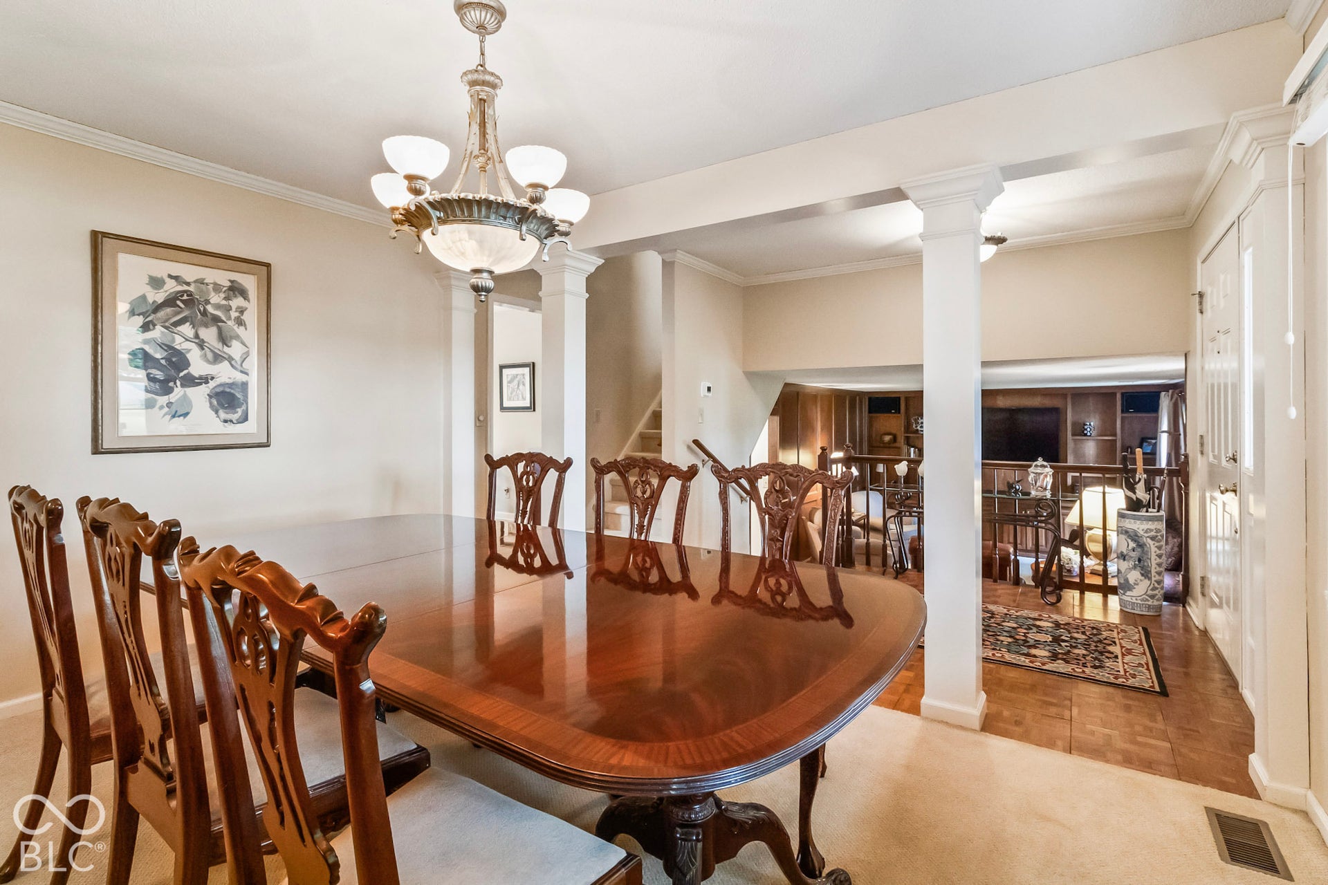 10954 N County Road 150 Road E, Pittsboro, IN 46167 Interior space featuring decorative columns, a traditional multi-arm chandelier, and parquet flooring