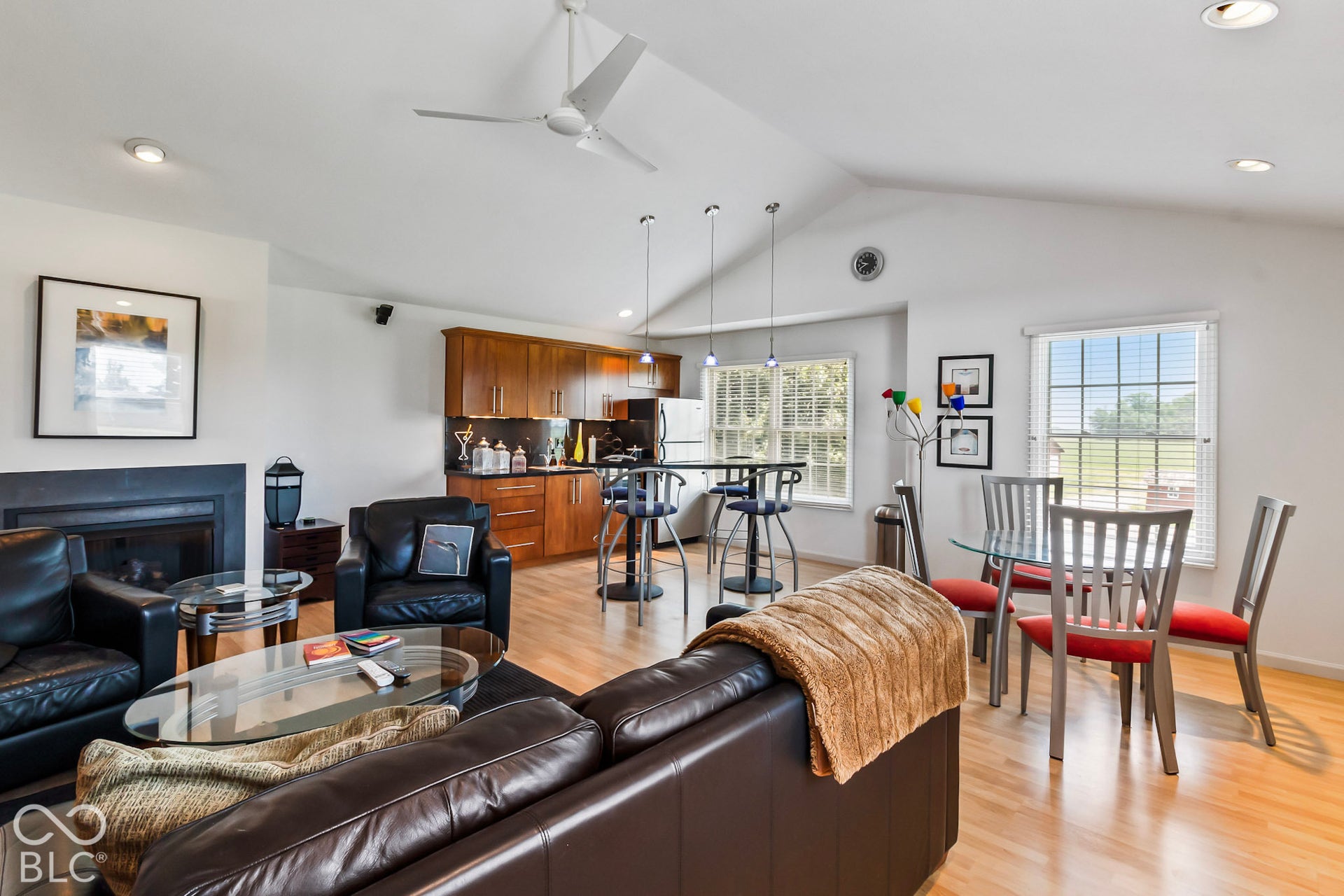 10954 N County Road 150 Road E, Pittsboro, IN 46167 Vaulted ceilings, wood-finish flooring, cabinetry with metallic hardware, recessed lighting, and a fireplace with a dark surround
