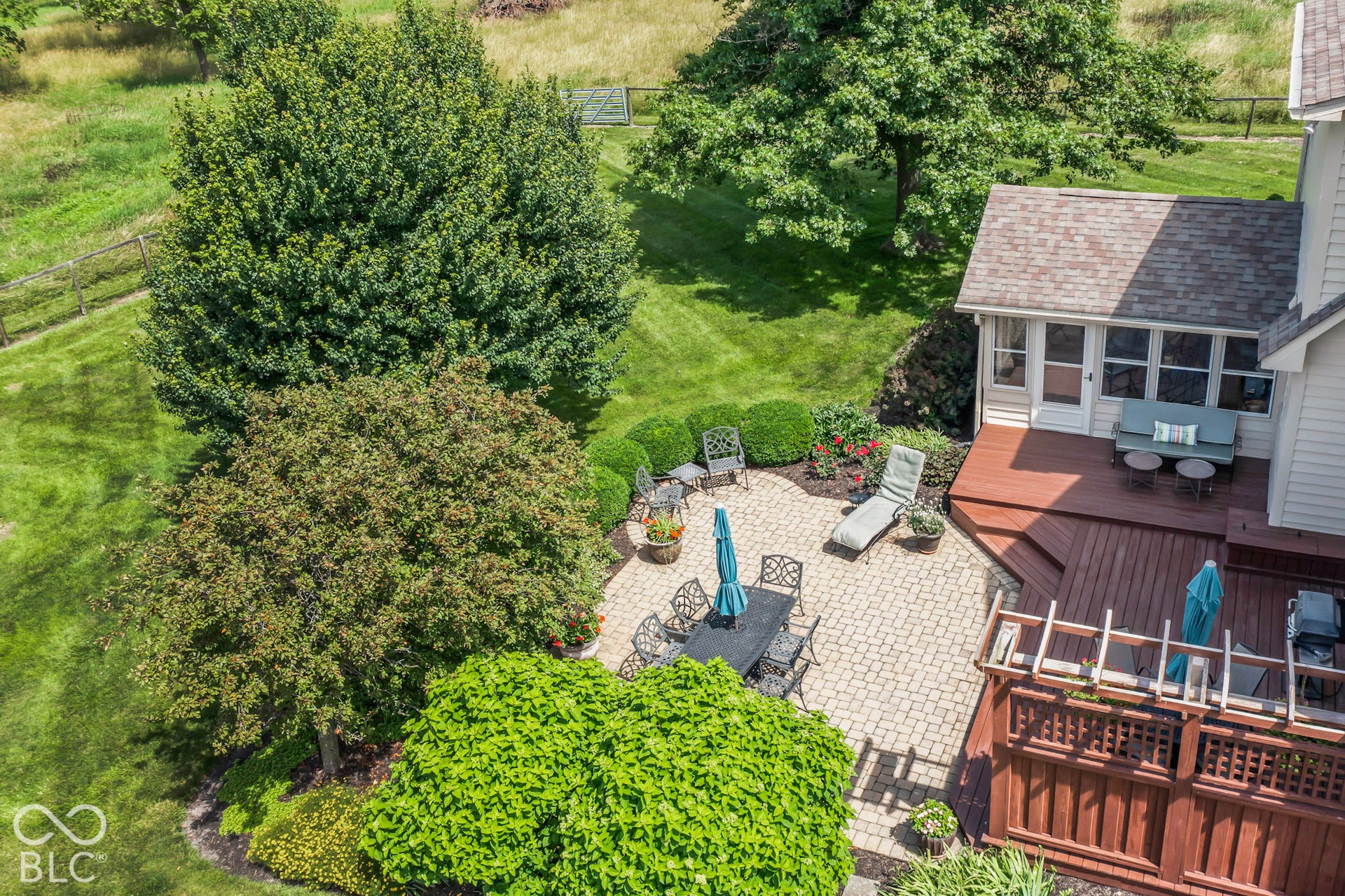 10954 N County Road 150 Road E, Pittsboro, IN 46167 Backyard featuring a paved stone patio, multi-level wood deck, wooden pergola, and mature landscaping