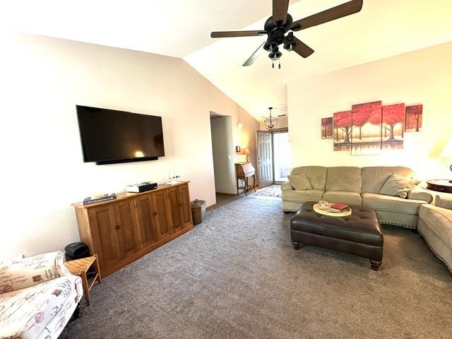 1712 Austin Drive, Lebanon, IN 46052 Vaulted ceiling with a ceiling fan, wall-mounted television, wood-finish console, and gray carpeting