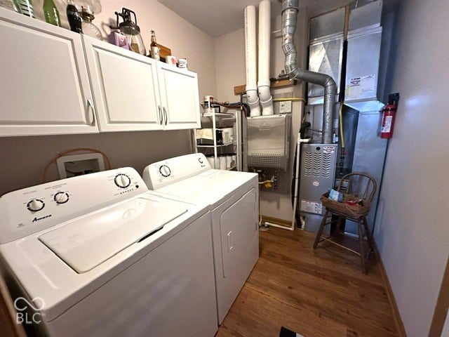1712 Austin Drive, Lebanon, IN 46052 White paneled upper cabinetry, wood-finish flooring, and utility hookups