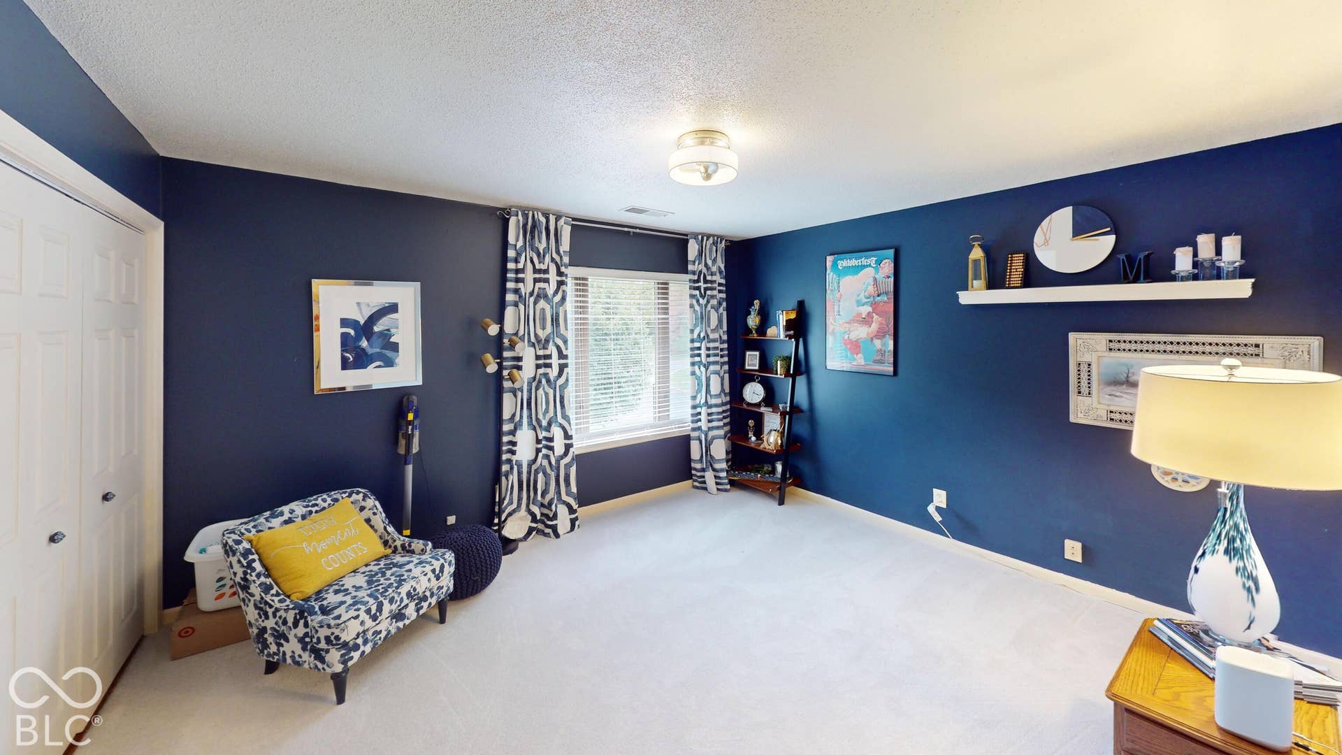 201 Bluffs Circle, Noblesville, IN 46062 BEDROOM #2 | Spacious bedroom showcasing rich navy blue walls, carpet flooring, and abundant natural light from dual windows