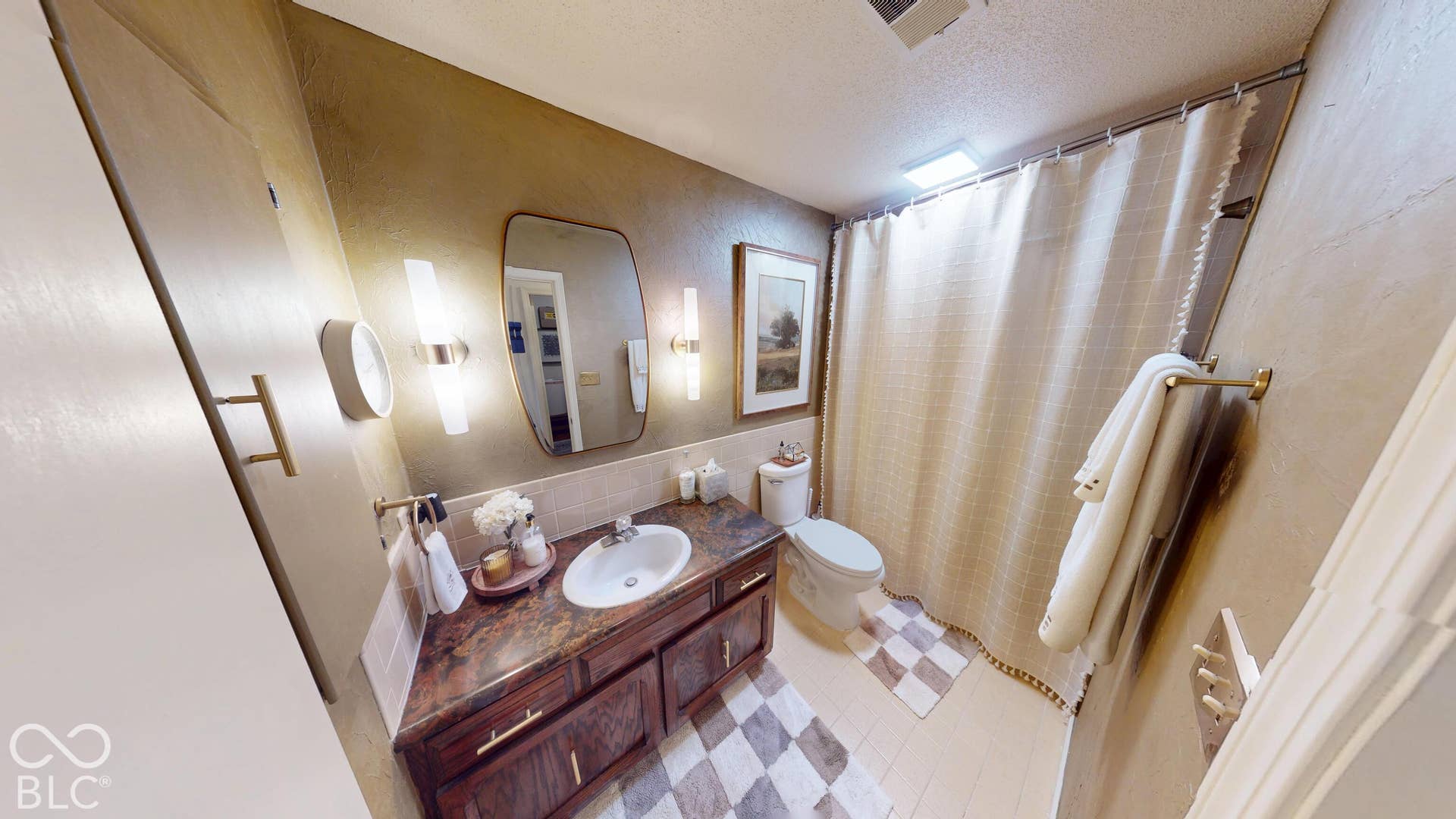 201 Bluffs Circle, Noblesville, IN 46062 Vanity with integrated sink, dark wood-finish cabinetry, and gold-tone hardware